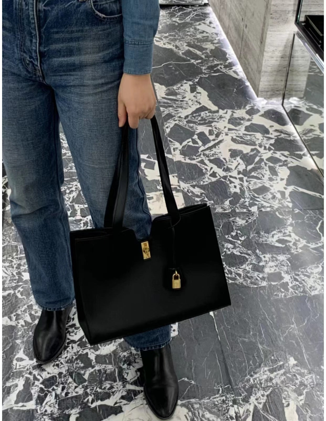 Elegant Black Leather Tote Bag with Gold Hardware and Padlock Accent