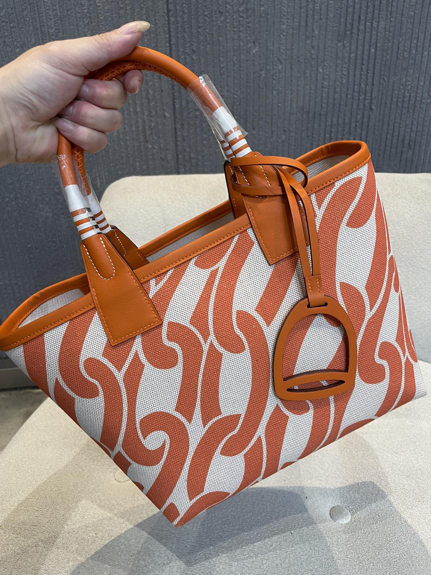 Orange Chain Link Pattern Canvas Tote Bag with Leather Top Handles and Stirrup Charm
