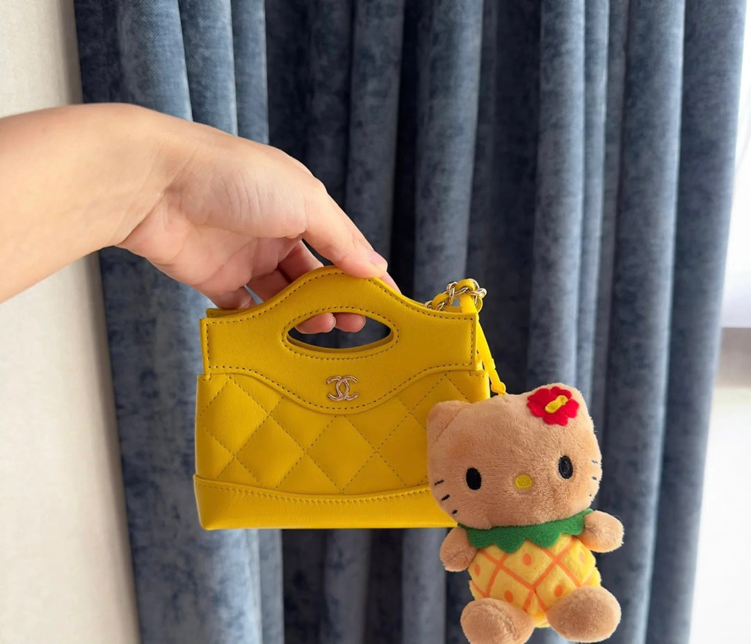 Yellow Quilted Mini Handbag with Gold Chain Strap and Top Handle