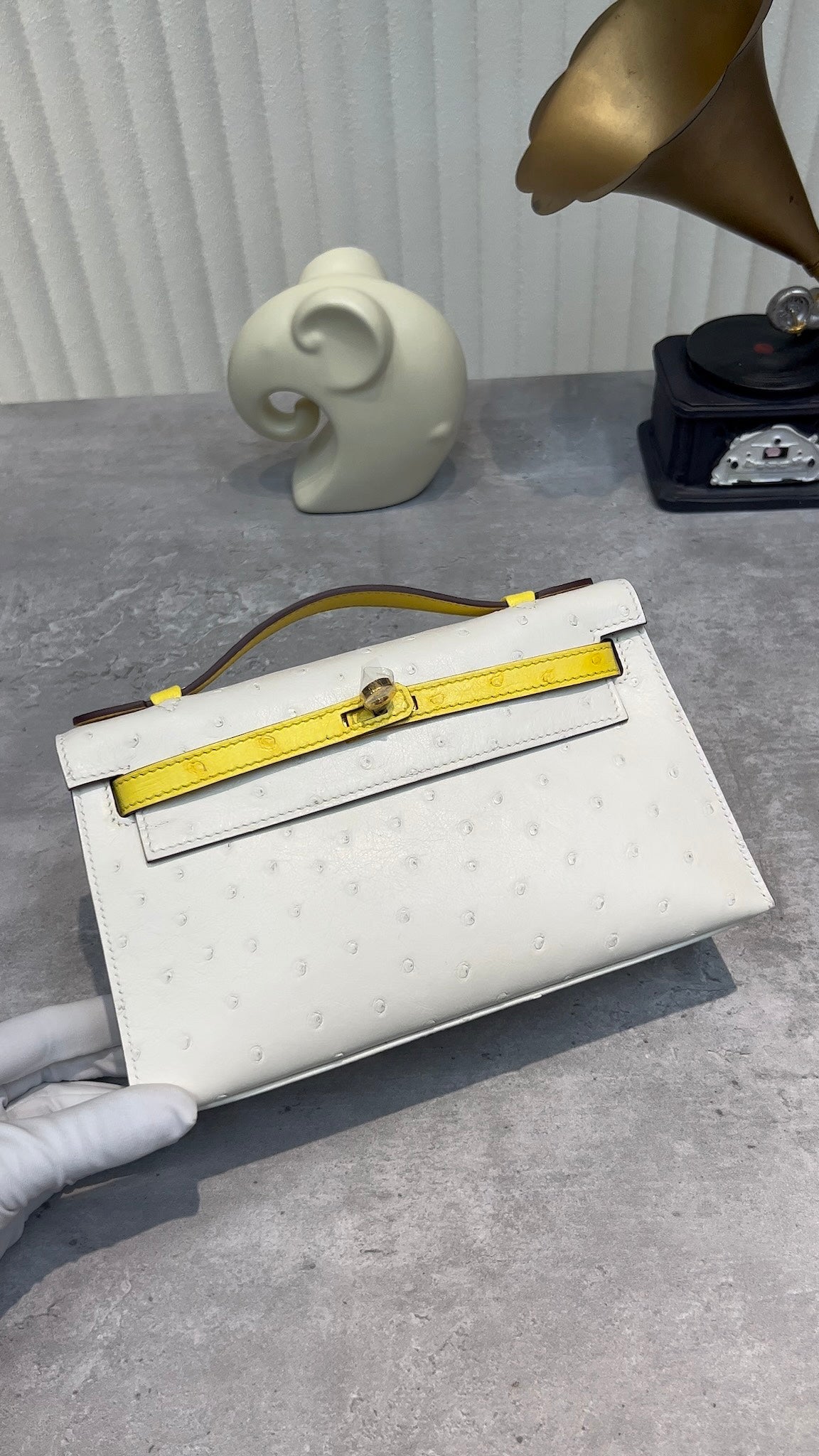 White Ostrich Embossed Top Handle Handbag with Yellow Trim and Gold Twist Lock