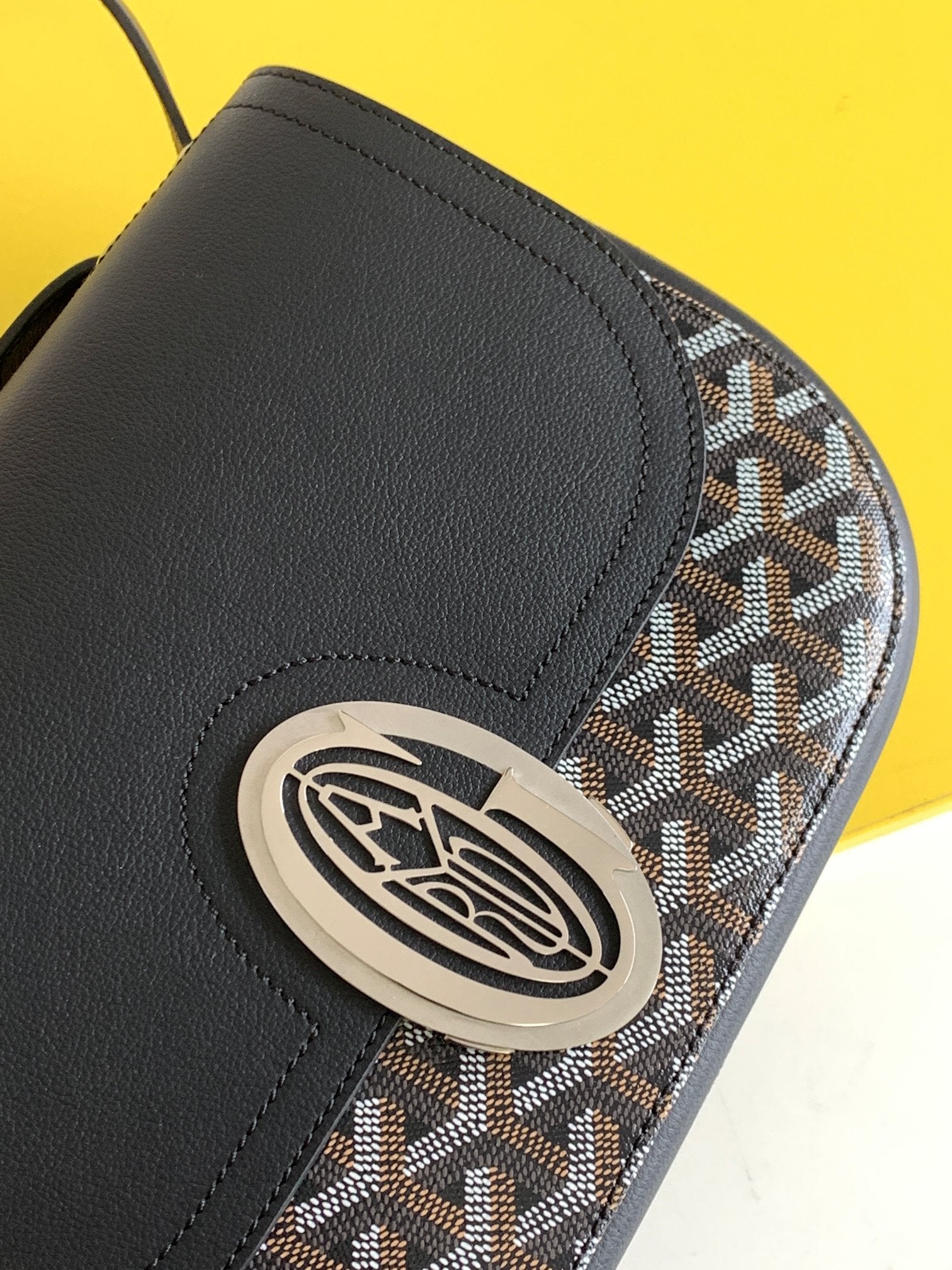 Gogy Black Leather Crossbody Bag with Chevron Monogram Print and Oval Clasp
