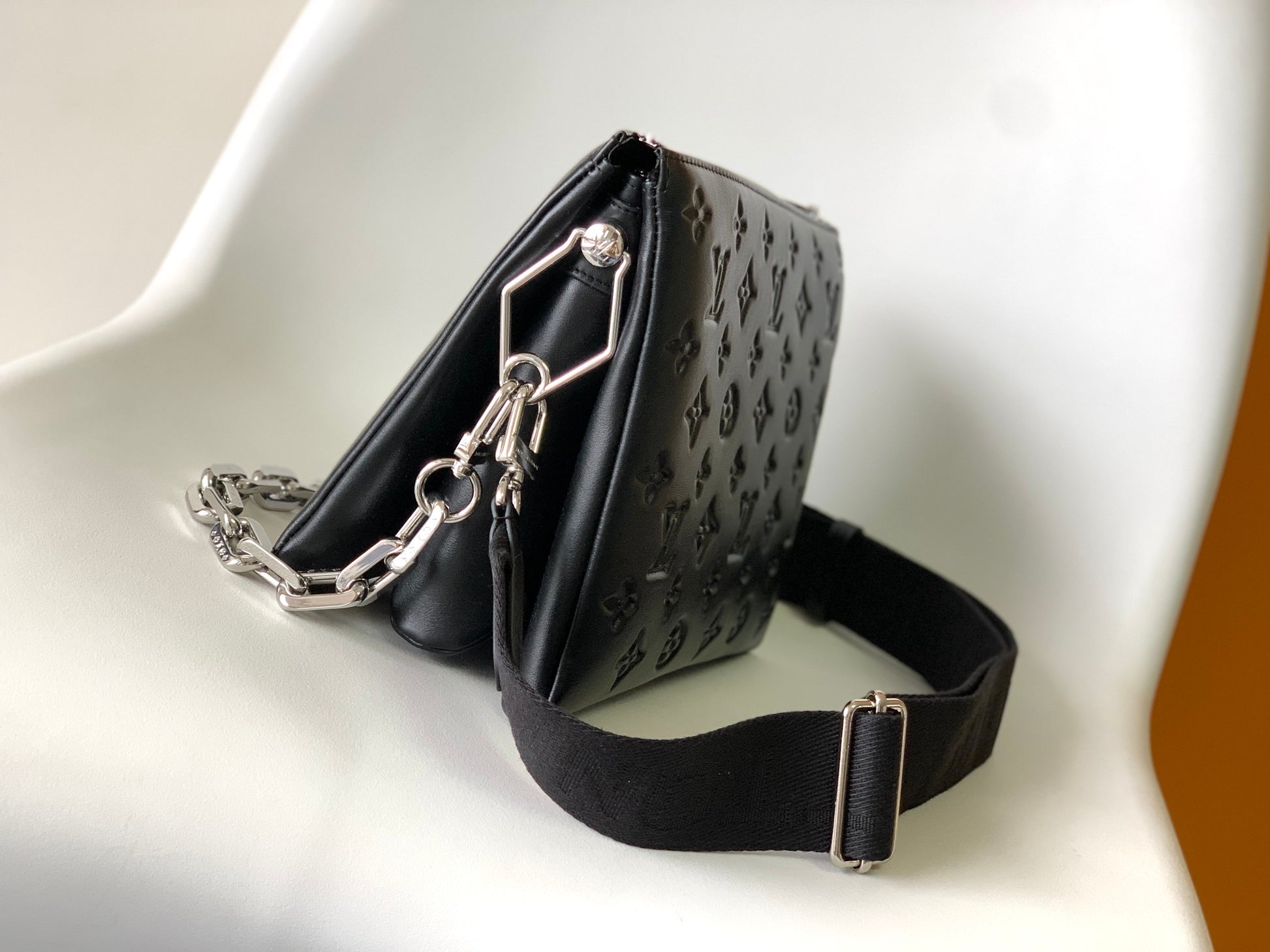 Black Embossed Monogram Crossbody Bag with Chain Detail and Wide Adjustable Strap