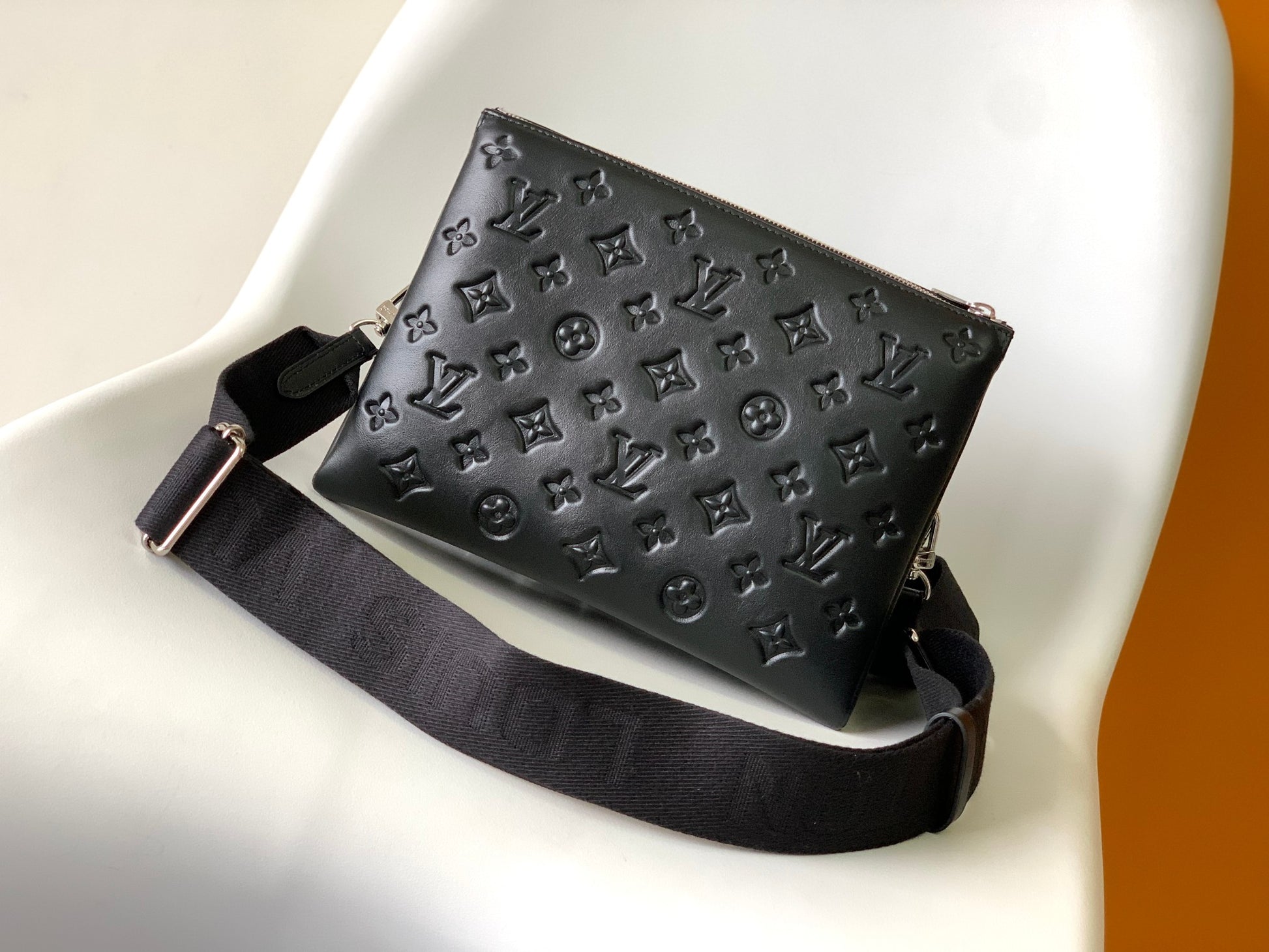 Black Embossed Monogram Crossbody Bag with Chain Detail and Wide Adjustable Strap