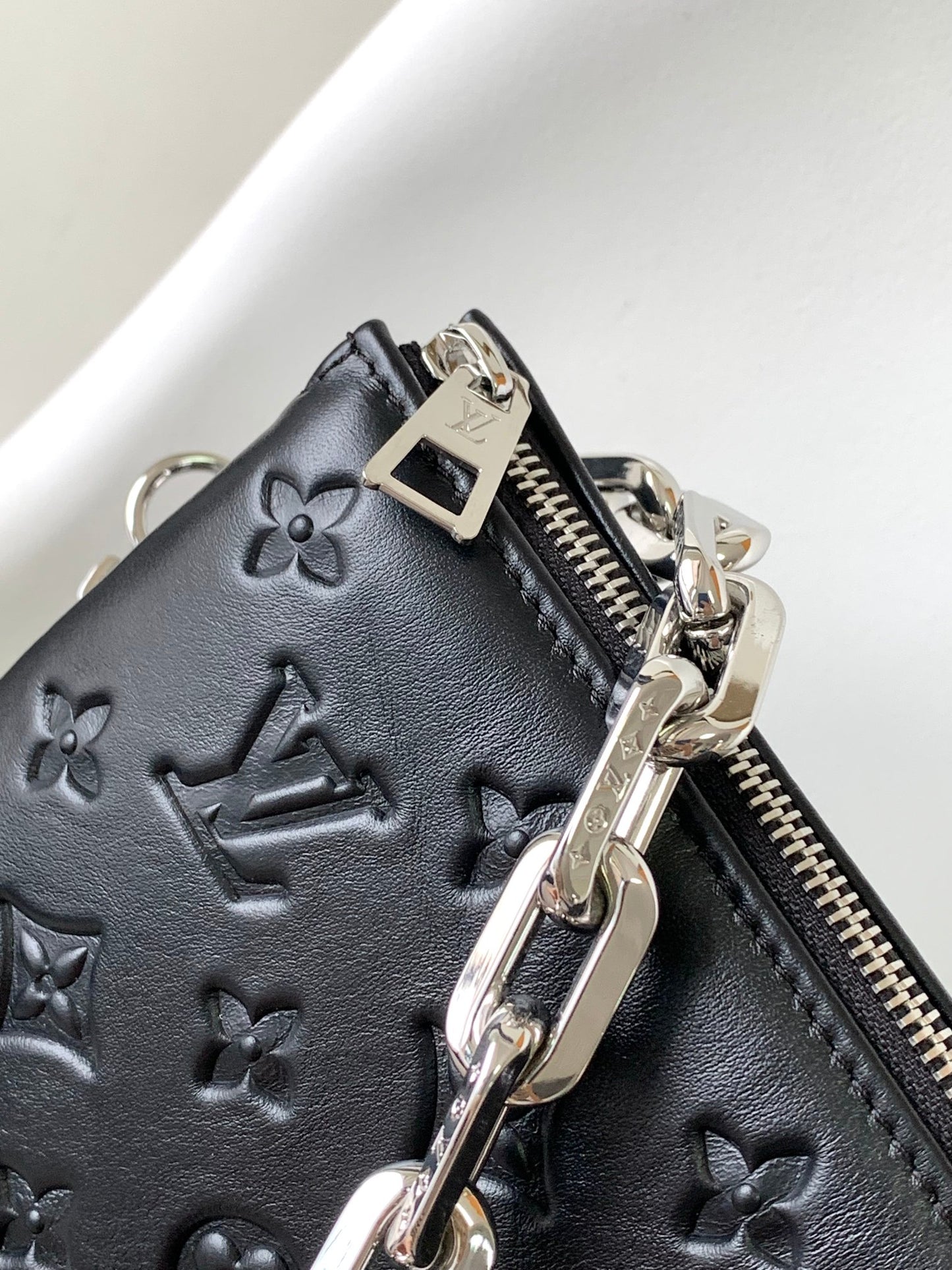 Black Embossed Monogram Crossbody Bag with Chain Detail and Wide Adjustable Strap