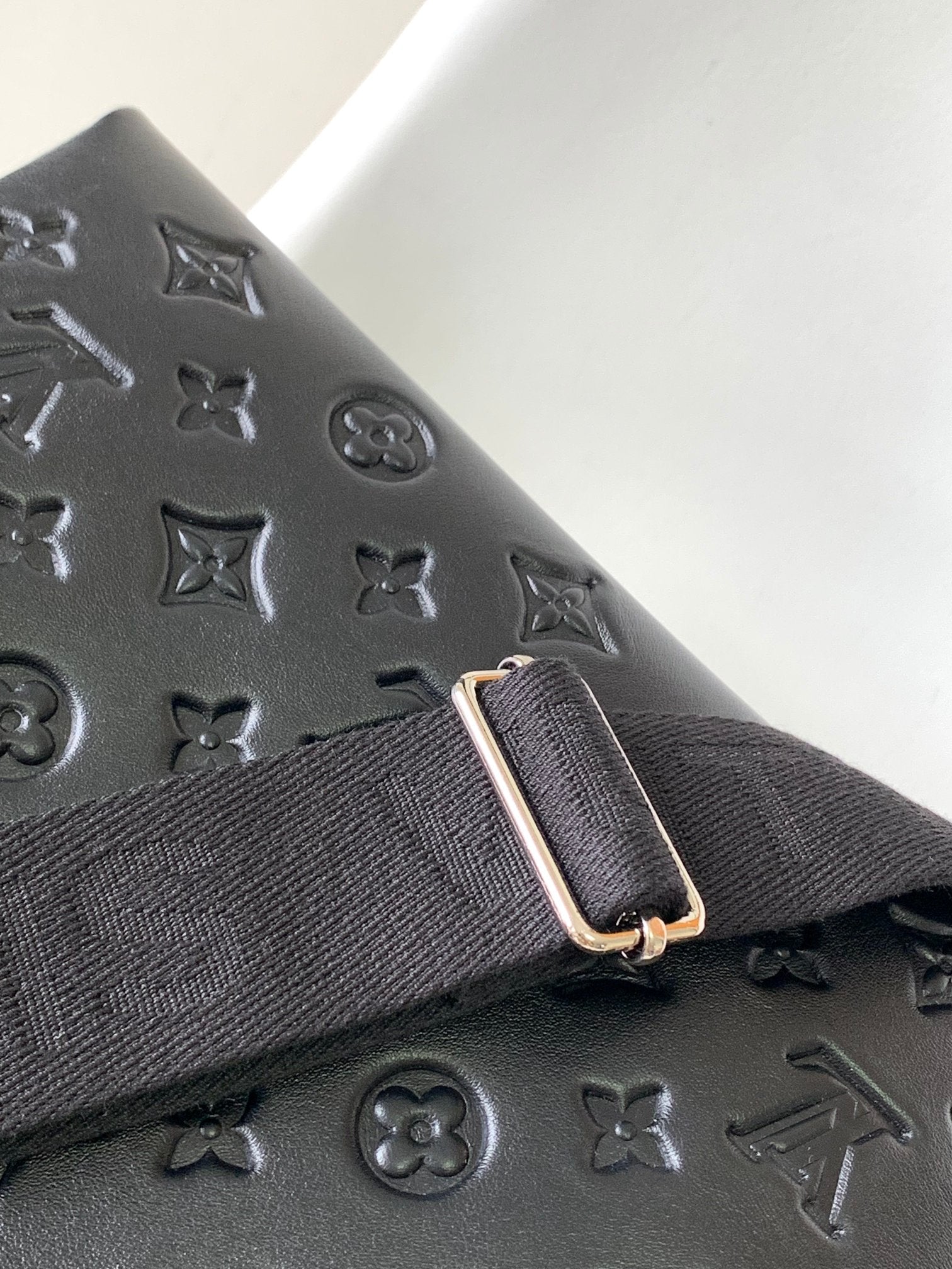 Black Embossed Monogram Crossbody Bag with Chain Detail and Wide Adjustable Strap