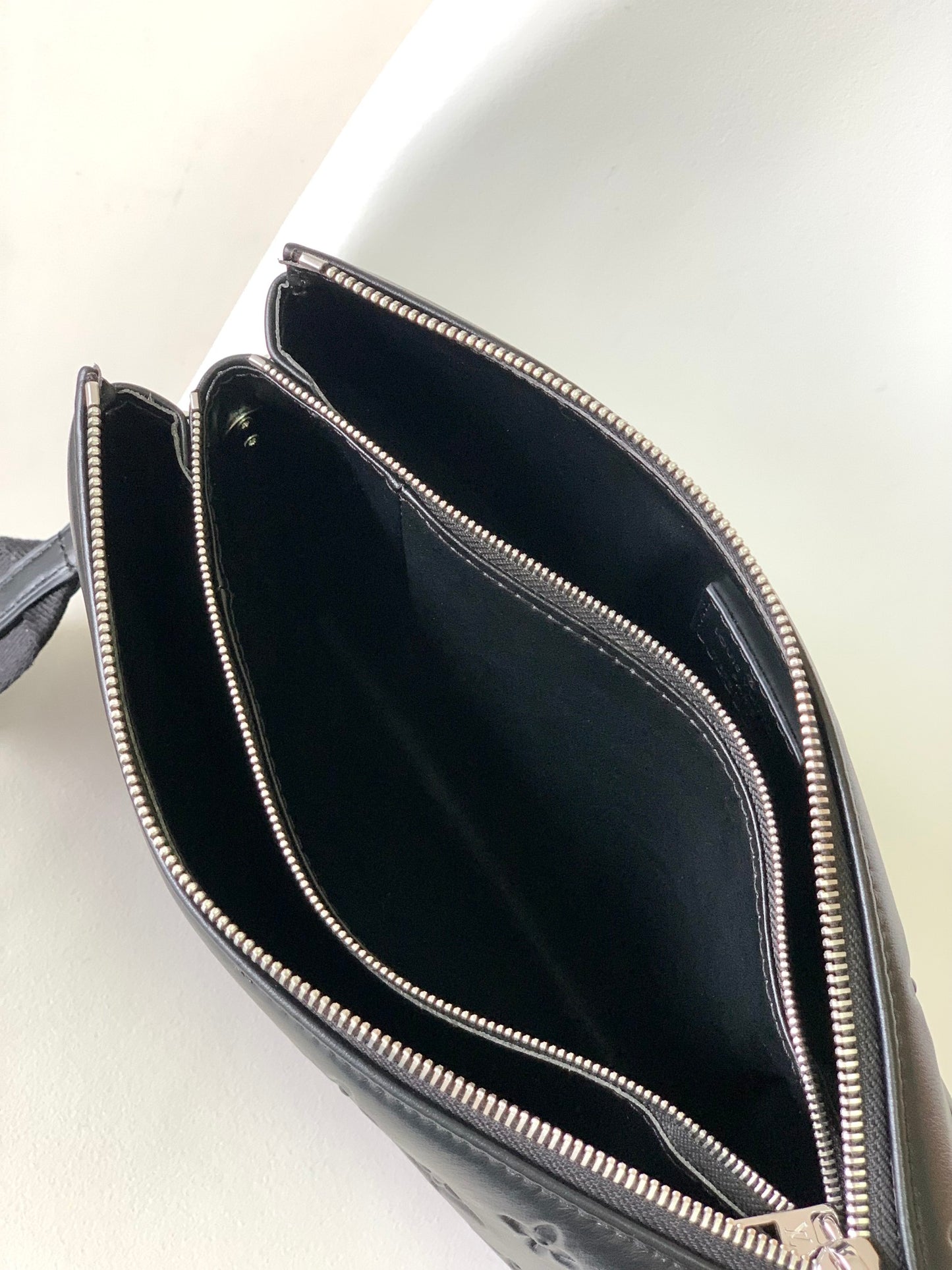Black Embossed Monogram Crossbody Bag with Chain Detail and Wide Adjustable Strap