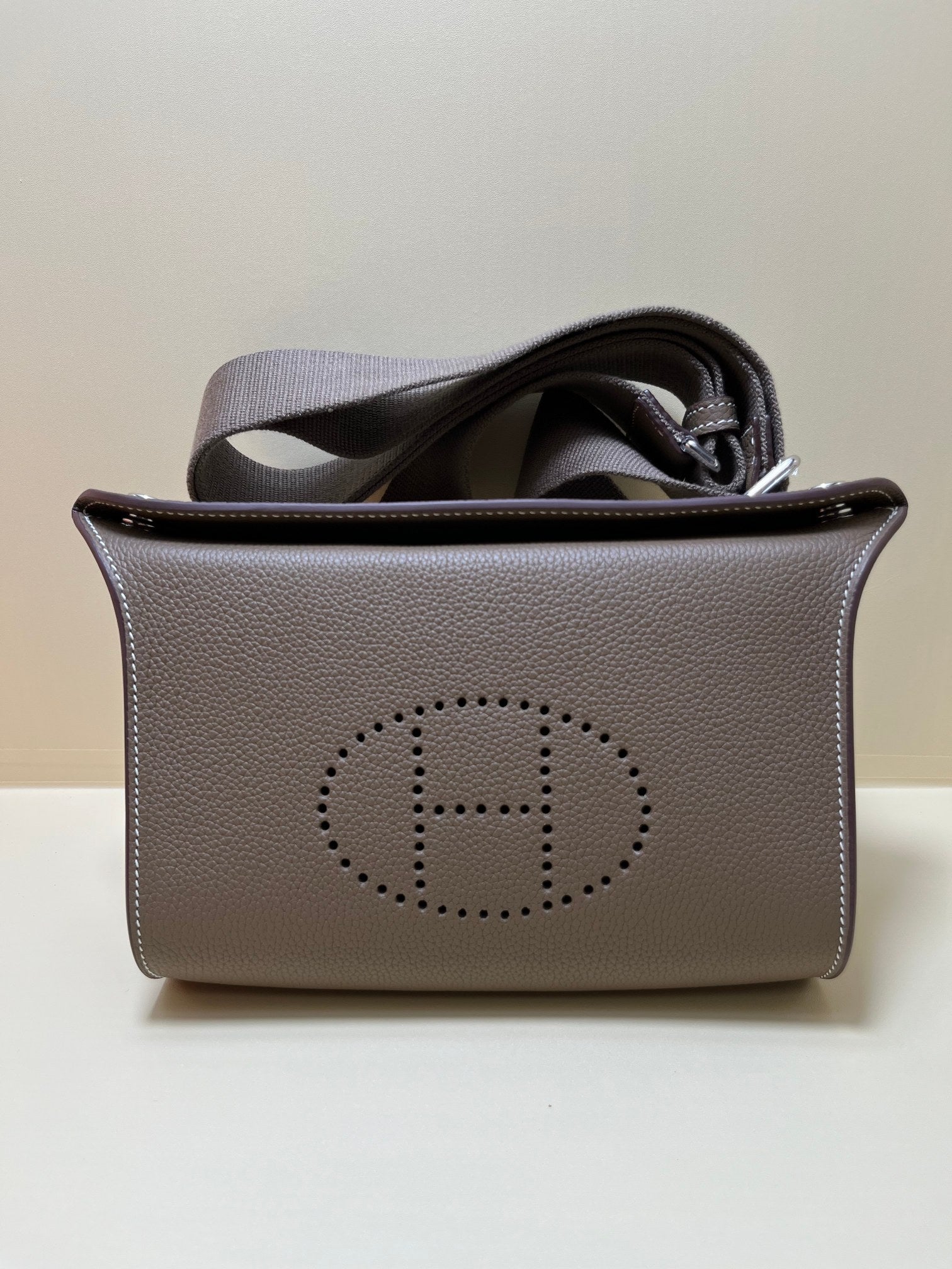 Luxury Pebbled Leather Crossbody Bag with Perforated H Logo - Taupe