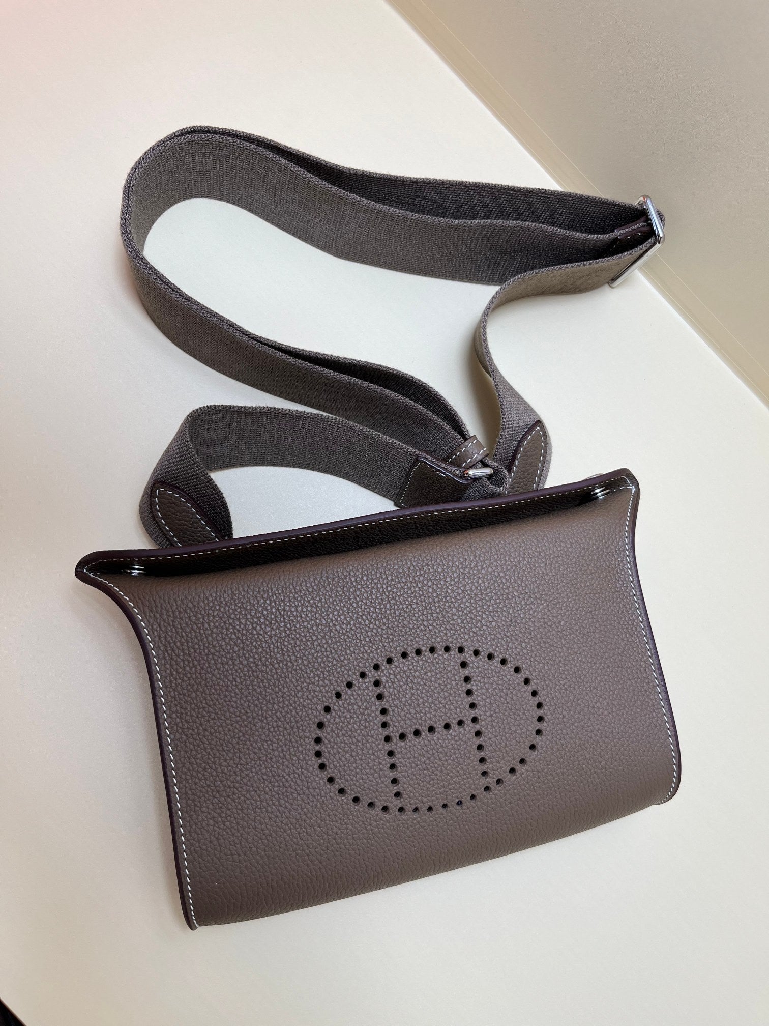 Luxury Pebbled Leather Crossbody Bag with Perforated H Logo - Taupe