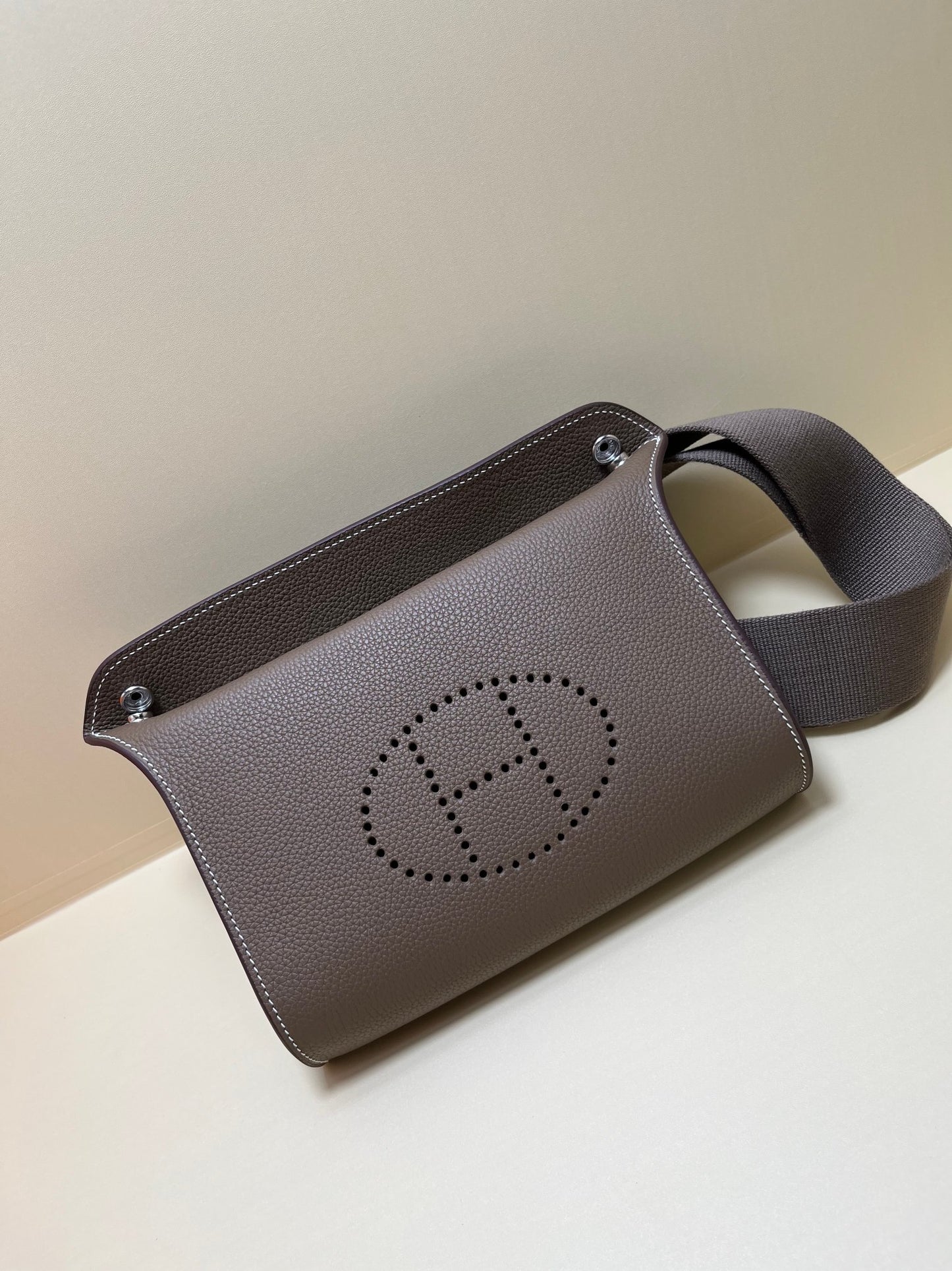 Luxury Pebbled Leather Crossbody Bag with Perforated H Logo - Taupe