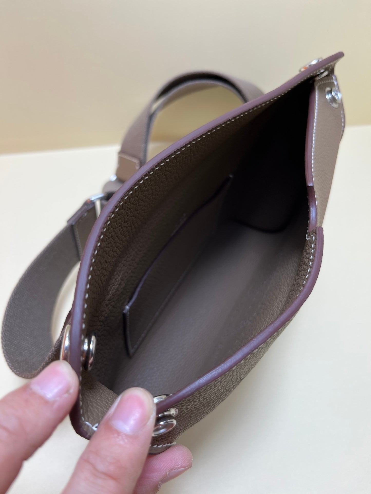 Luxury Pebbled Leather Crossbody Bag with Perforated H Logo - Taupe