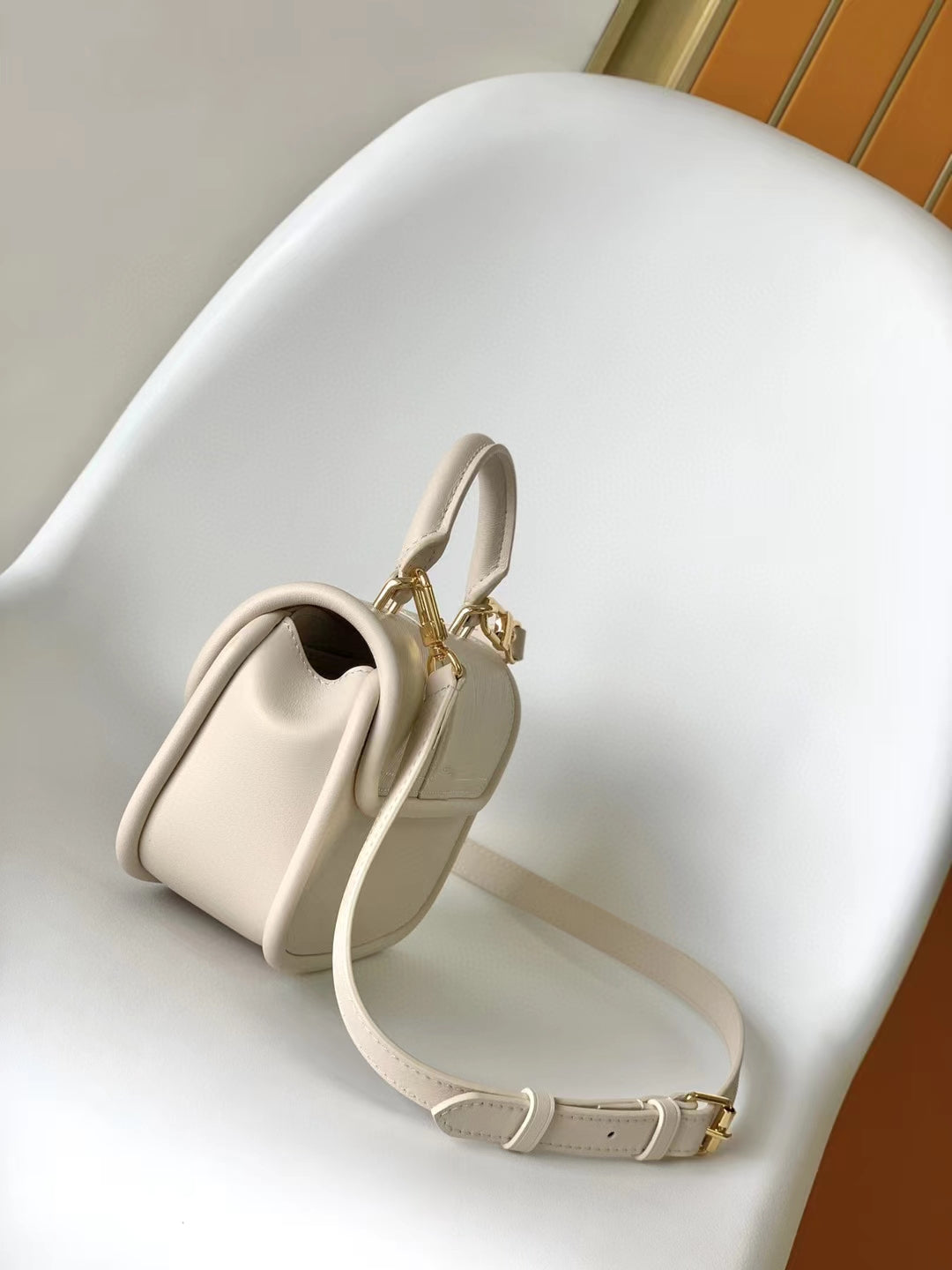 Elegant Beige Leather Micro Top Handle Bag with Gold Hardware