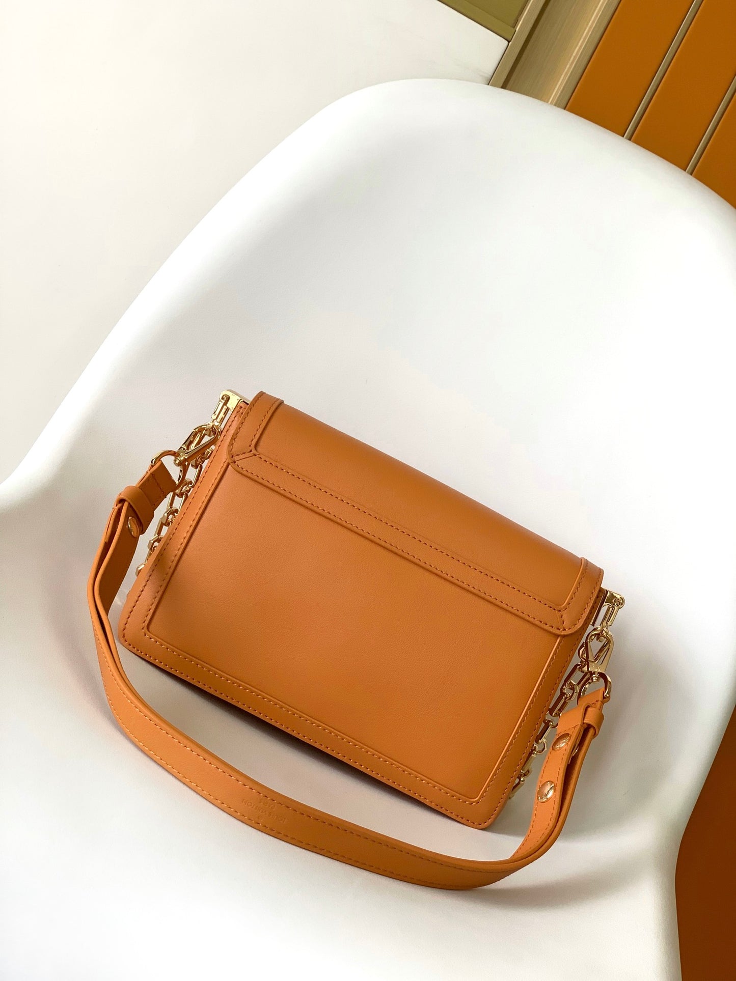 Women's Tan Leather Crossbody Handbag with Gold Chain Strap and Logo Buckle