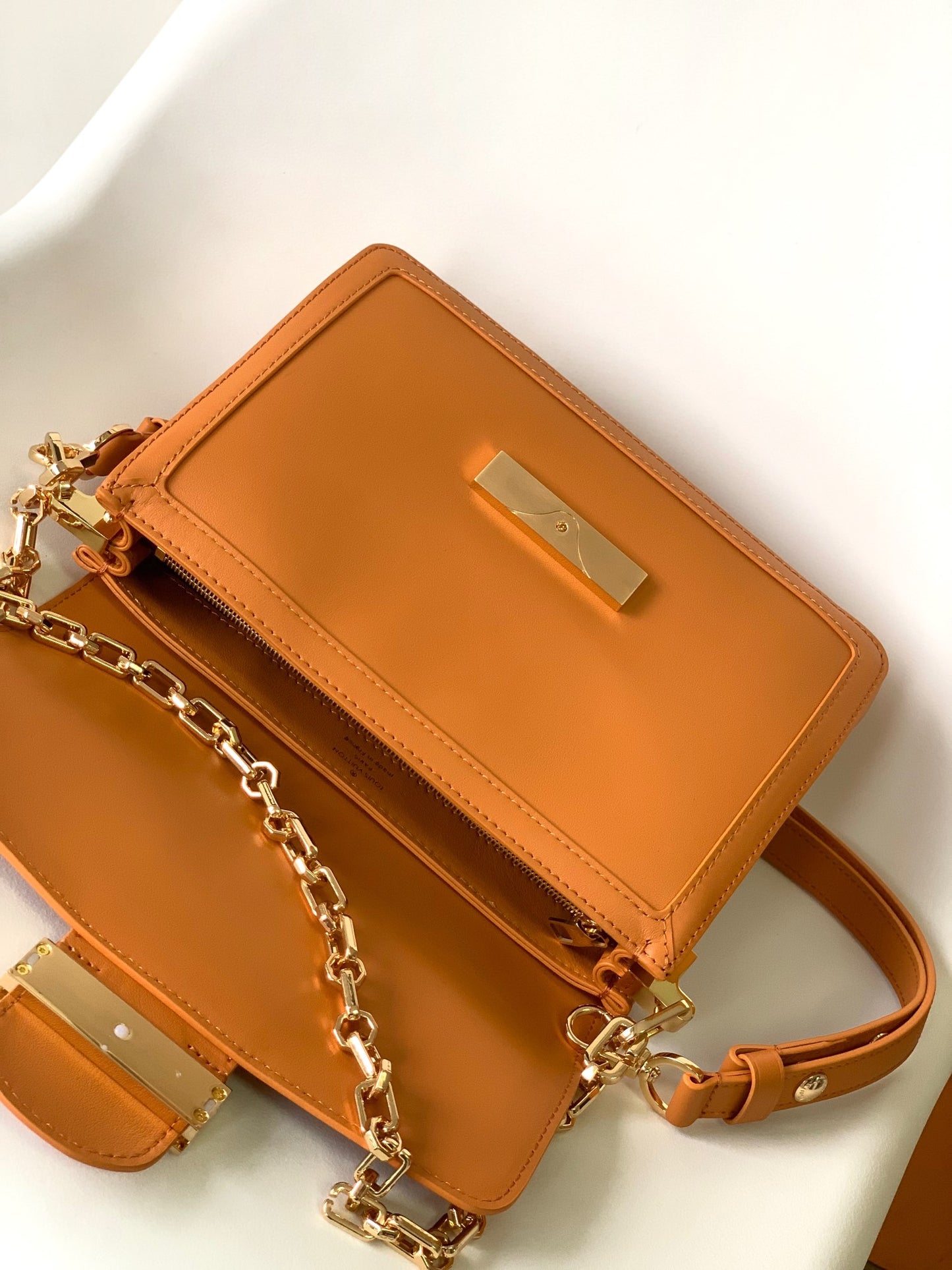 Women's Tan Leather Crossbody Handbag with Gold Chain Strap and Logo Buckle