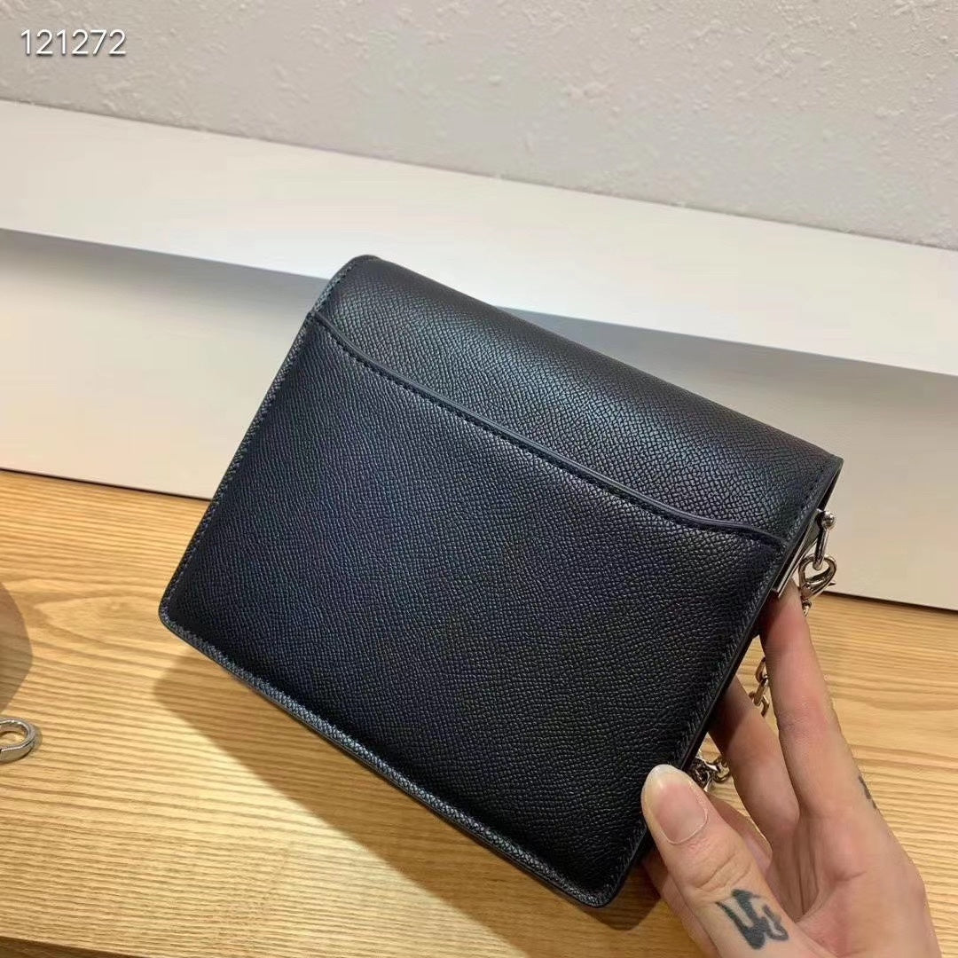Elegant Black Shoulder Bag with Silver-Tone Chain Strap and Decorative Front Clasp