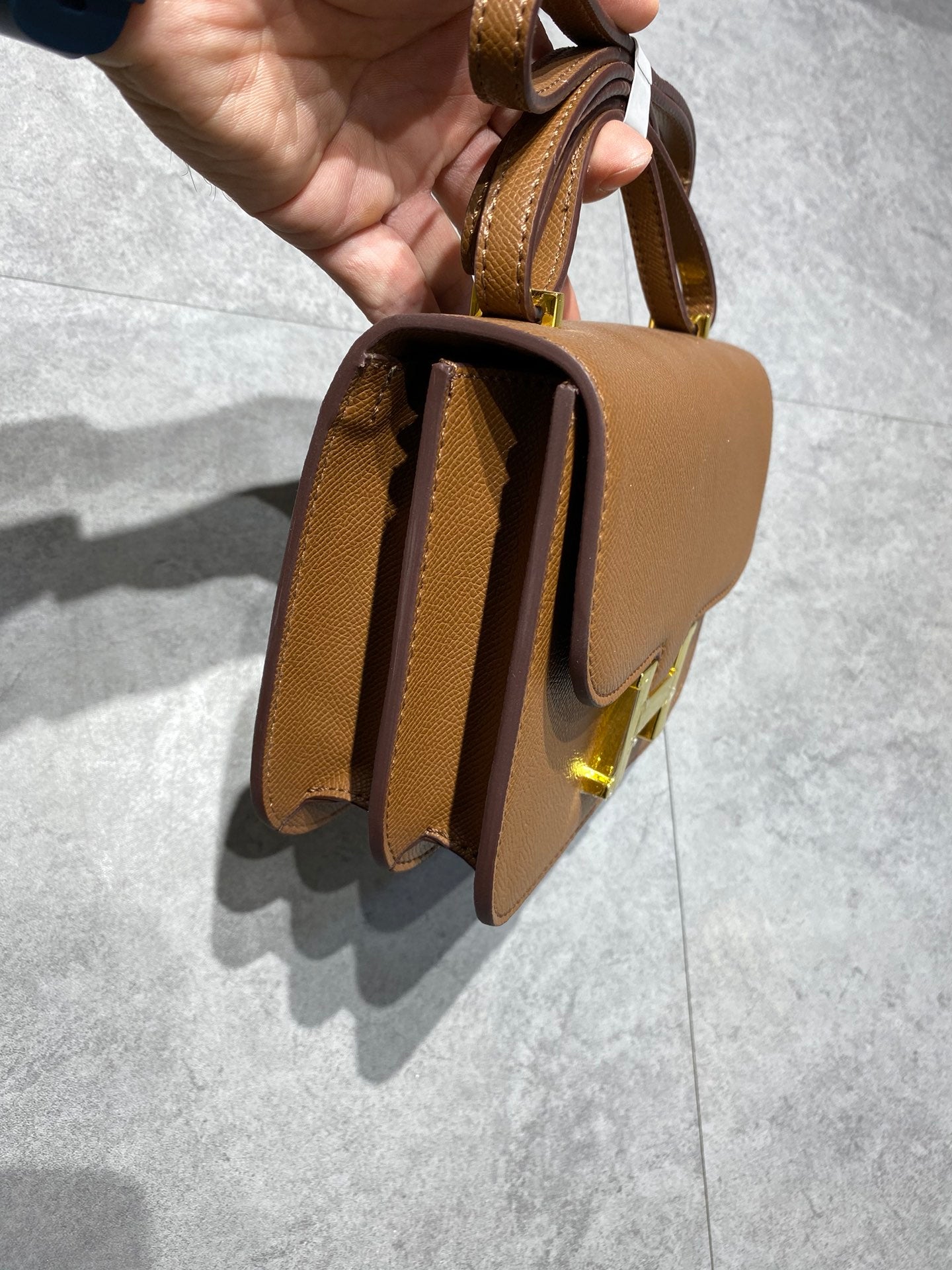 Elegant Tan Brown Leather Crossbody Bag with Gold-Tone H Buckle Hardware
