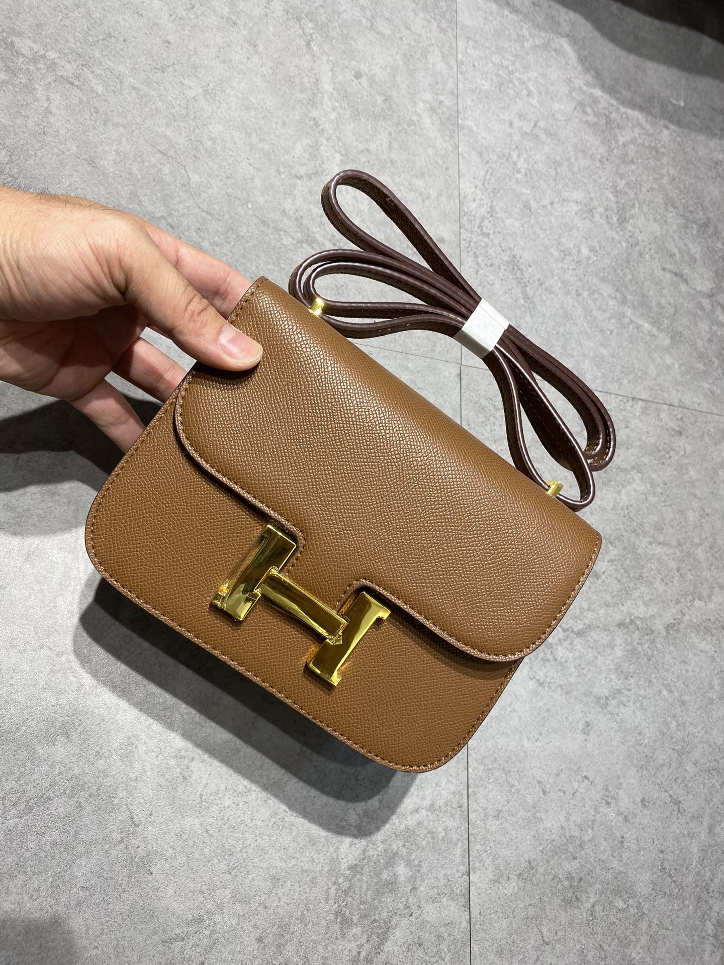 Elegant Tan Brown Leather Crossbody Bag with Gold-Tone H Buckle Hardware