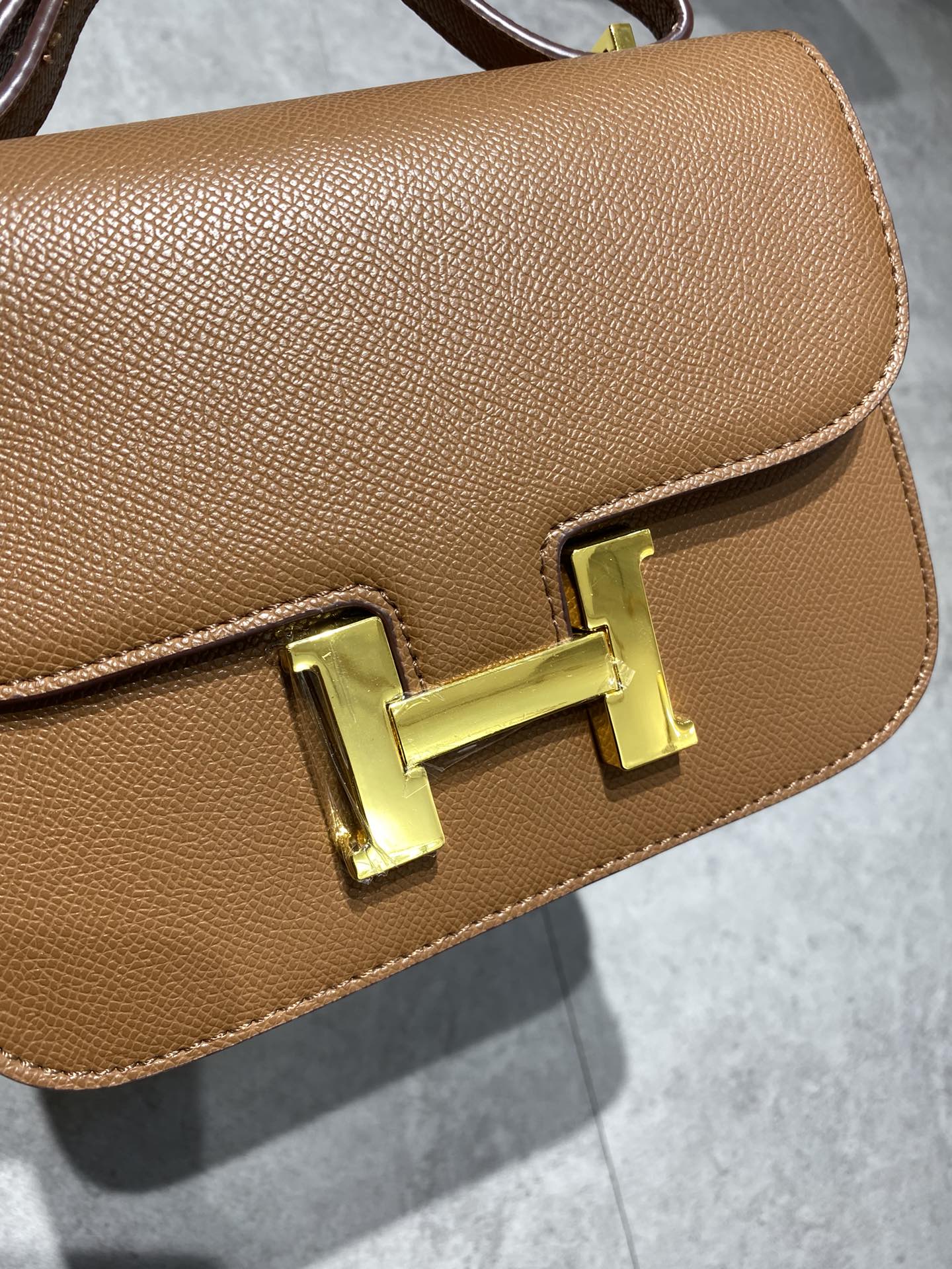 Elegant Tan Brown Leather Crossbody Bag with Gold-Tone H Buckle Hardware