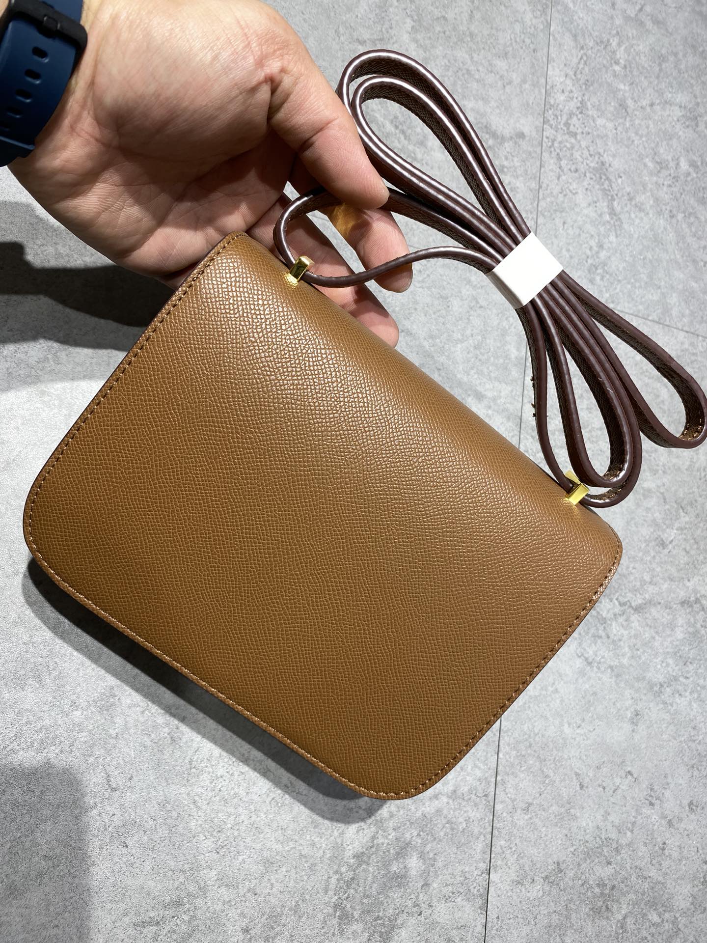 Elegant Tan Brown Leather Crossbody Bag with Gold-Tone H Buckle Hardware
