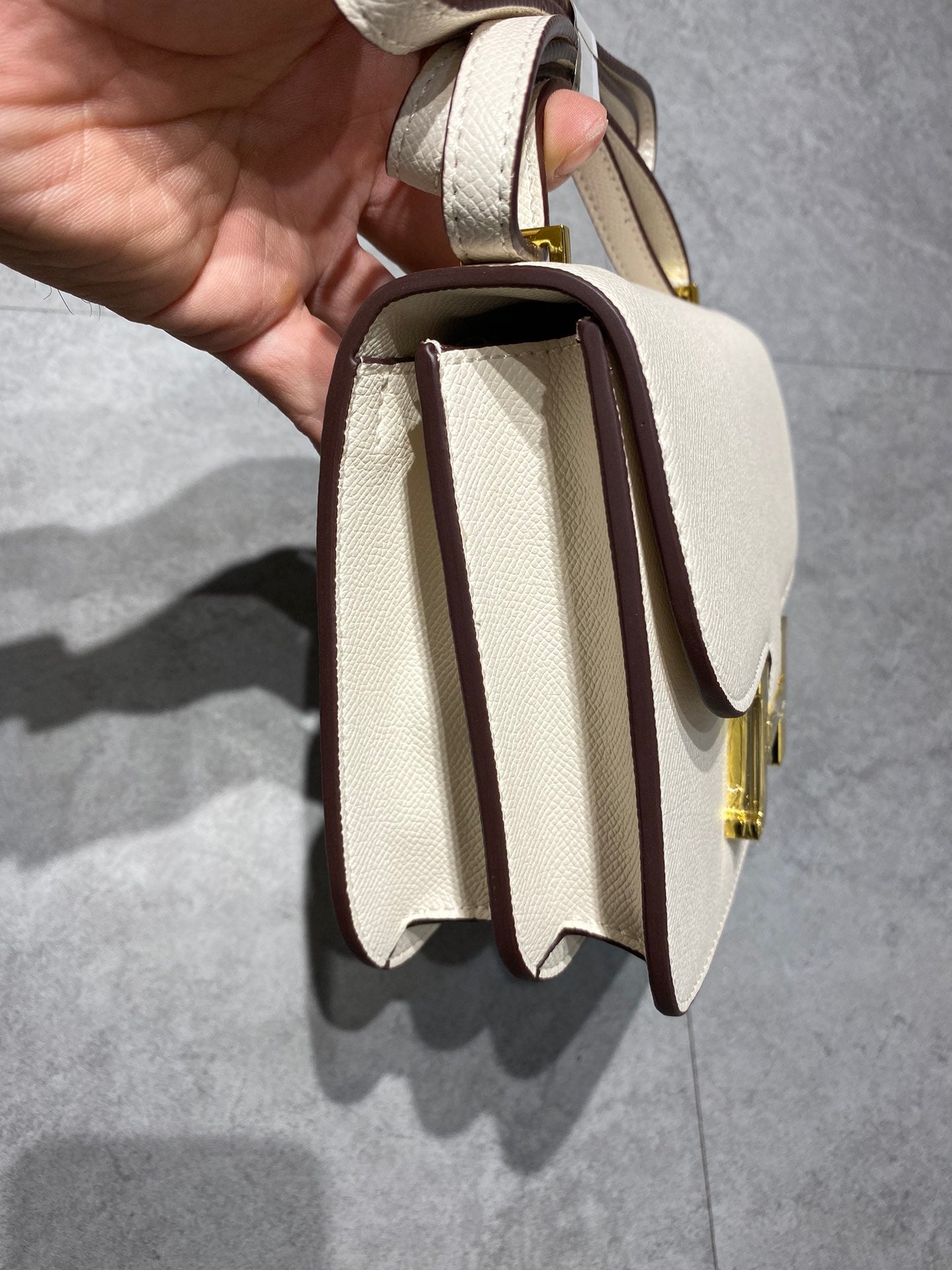 Elegant Cream Leather Crossbody Bag with Gold H Clasp
