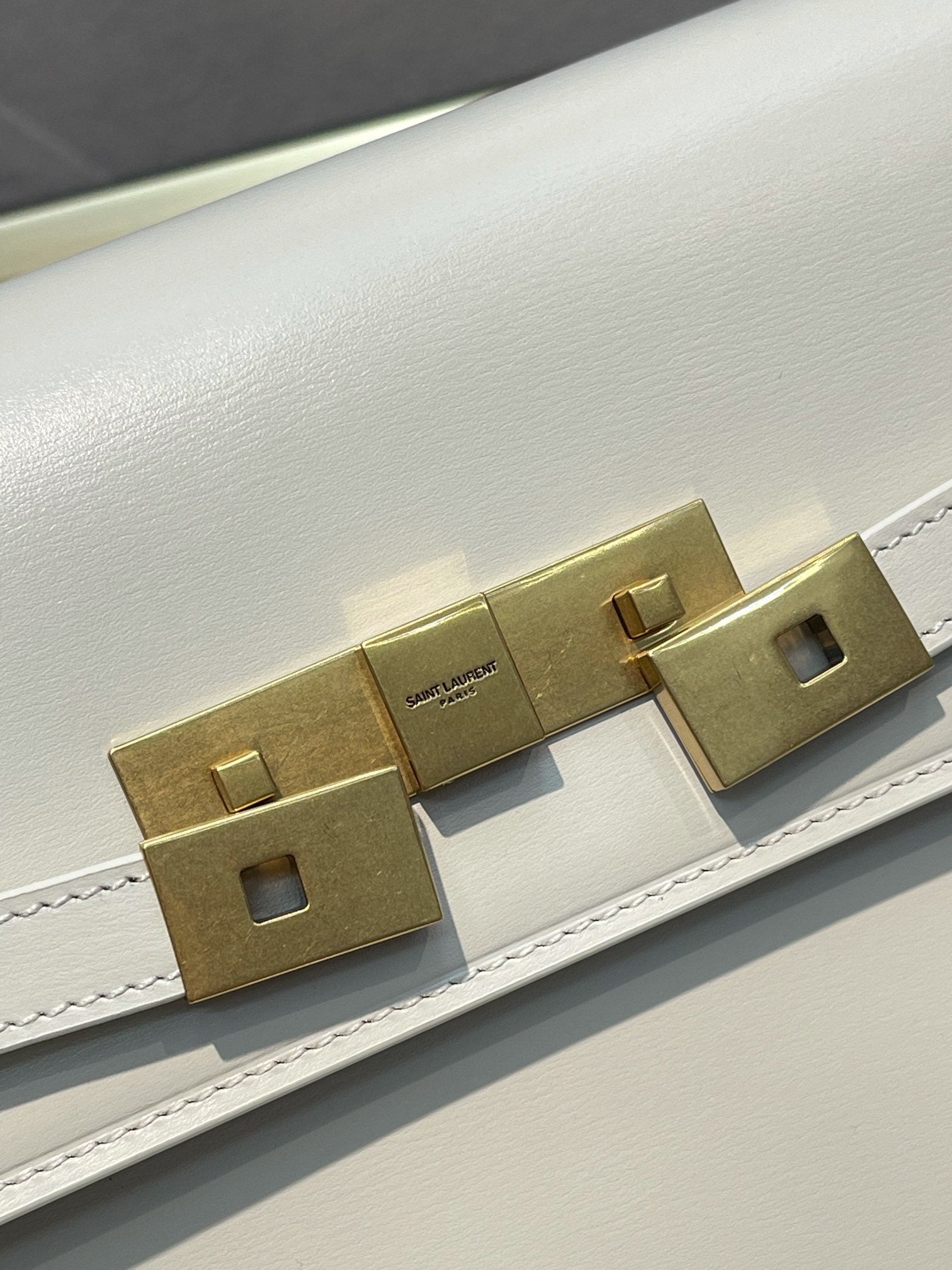 Elegant Women's Cream Leather Shoulder Bag with Gold Hardware and Buckle Detail