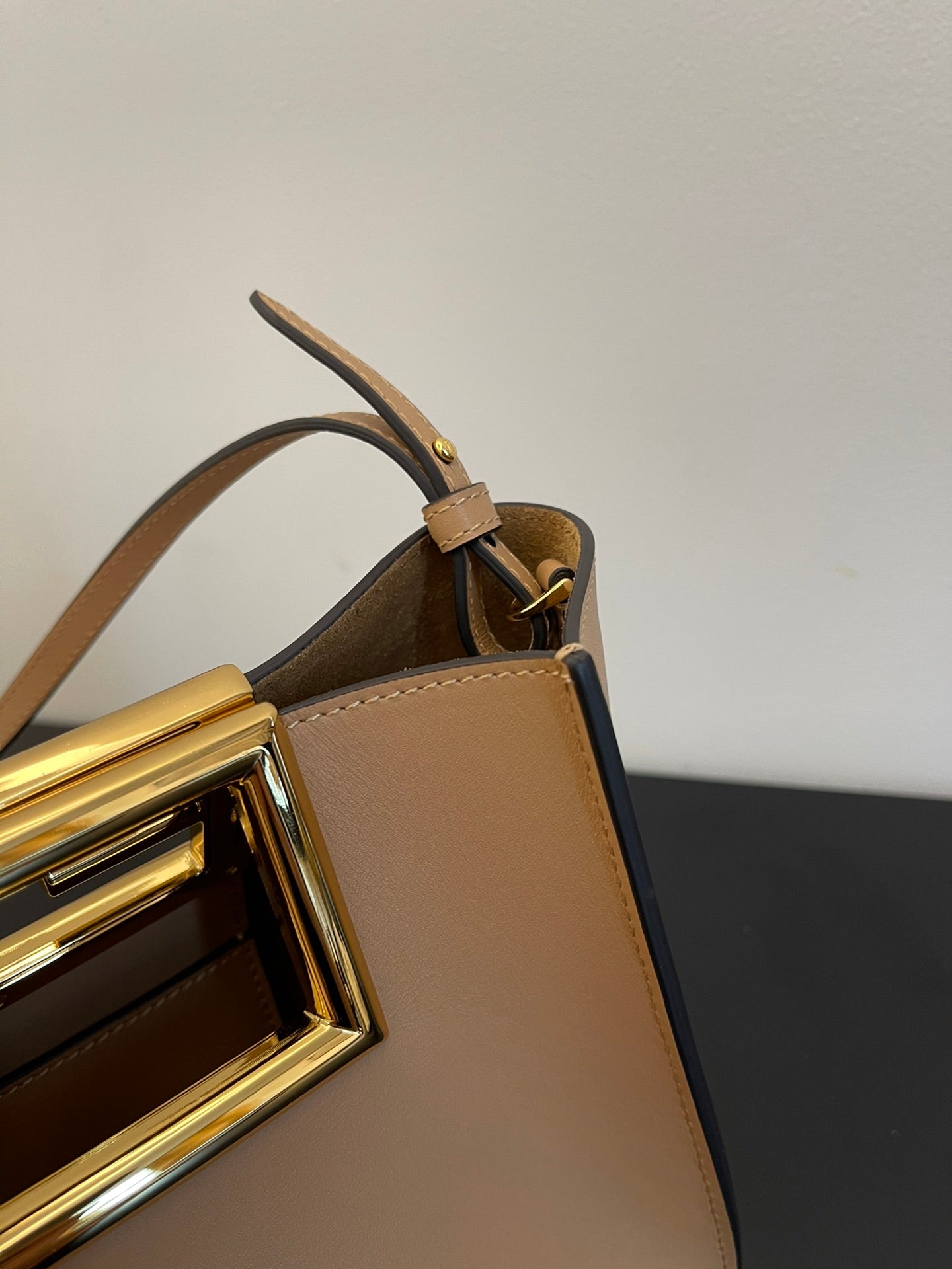 Tan Leather Bucket Bag with Gold Geometric Clasp and Shoulder Strap