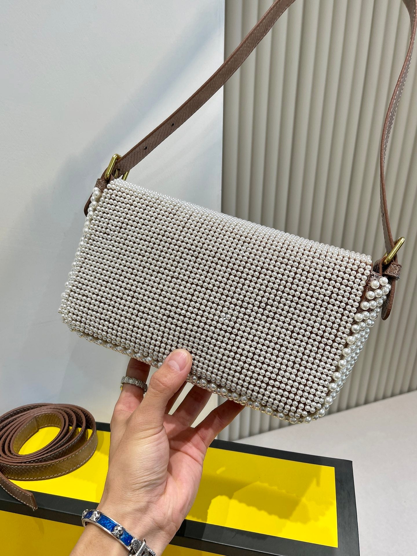 Elegant Textured Weave Baguette Shoulder Bag with Gold-Tone Buckle - Cream and Black