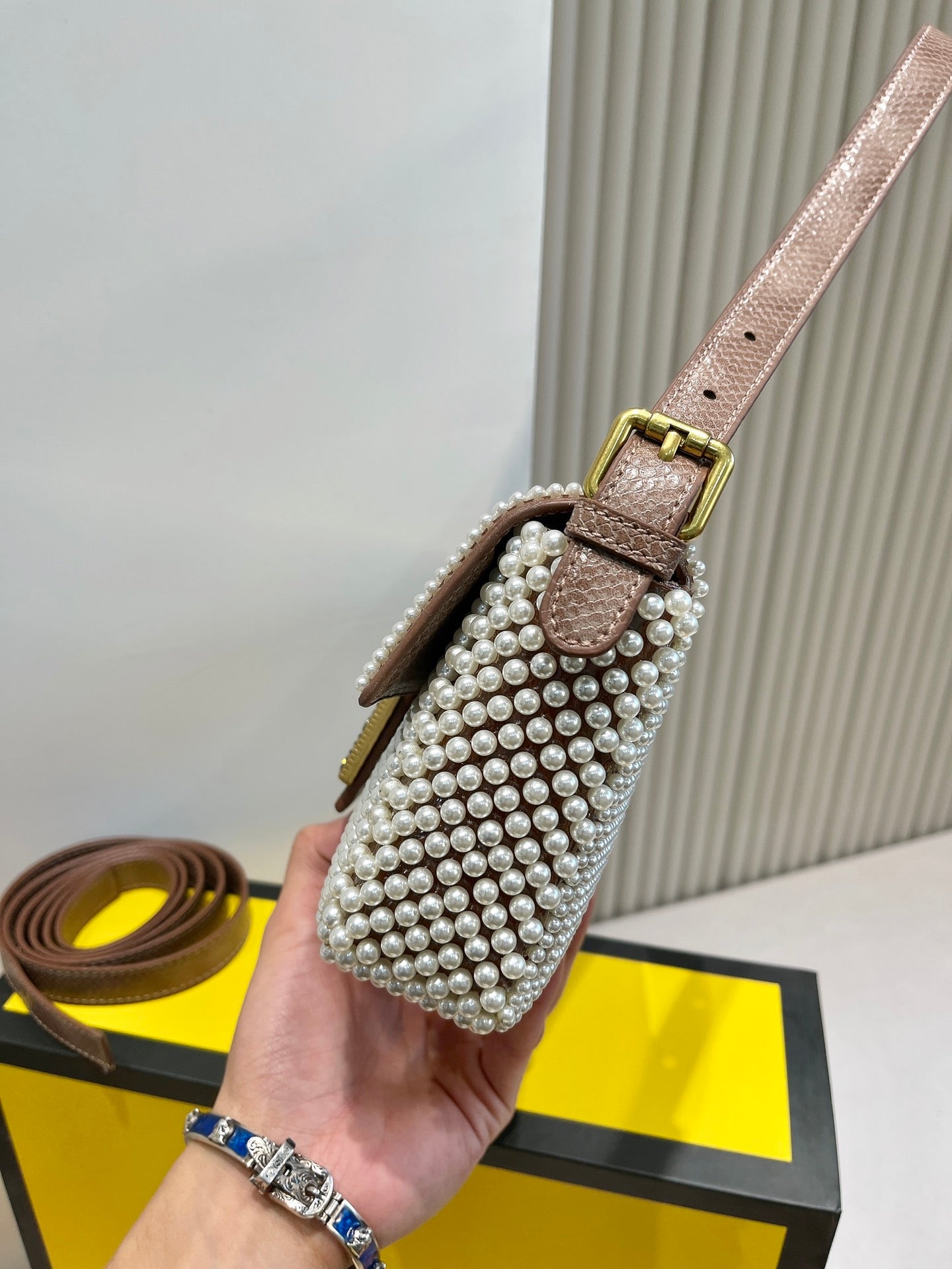 Elegant Textured Weave Baguette Shoulder Bag with Gold-Tone Buckle - Cream and Black