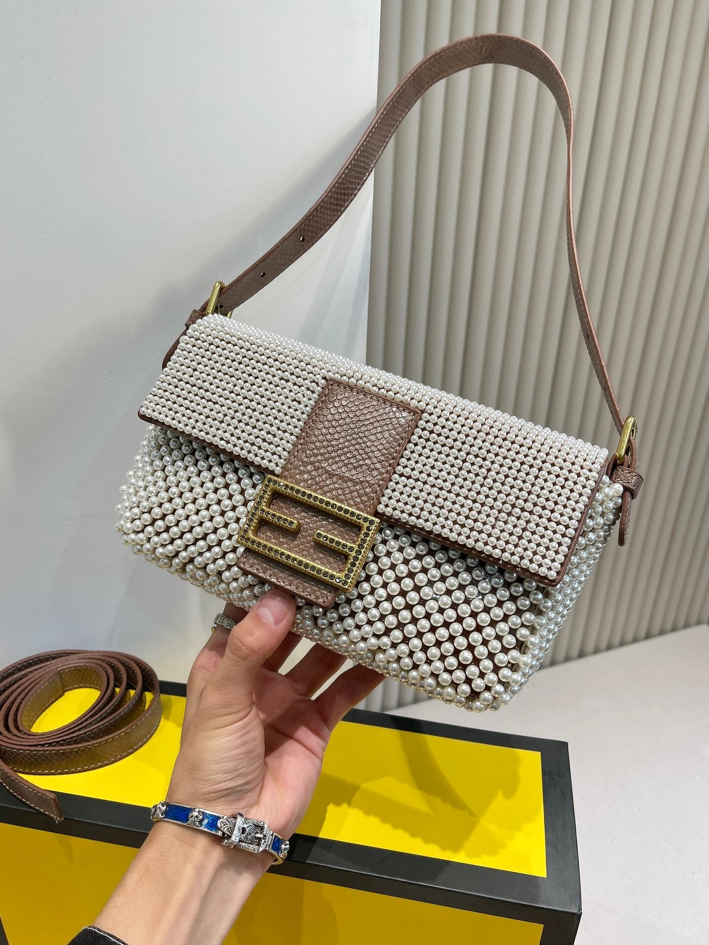 Elegant Textured Weave Baguette Shoulder Bag with Gold-Tone Buckle - Cream and Black
