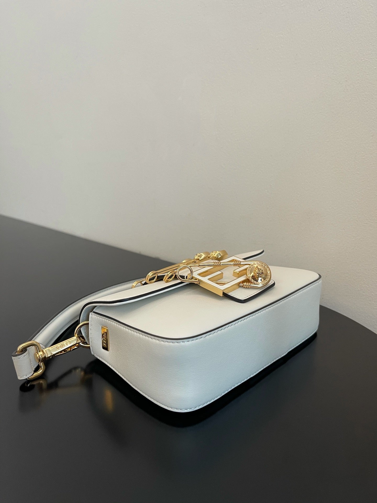 Elegant White Leather Mini Bag with Gold Flower Safety Pin Details