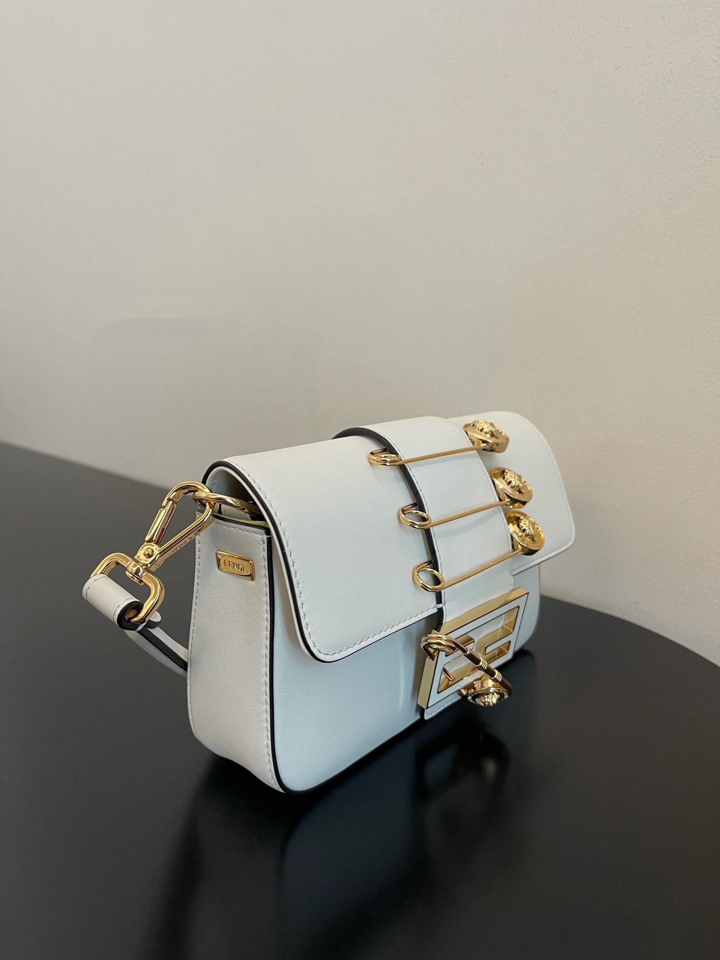 Elegant White Leather Mini Bag with Gold Flower Safety Pin Details