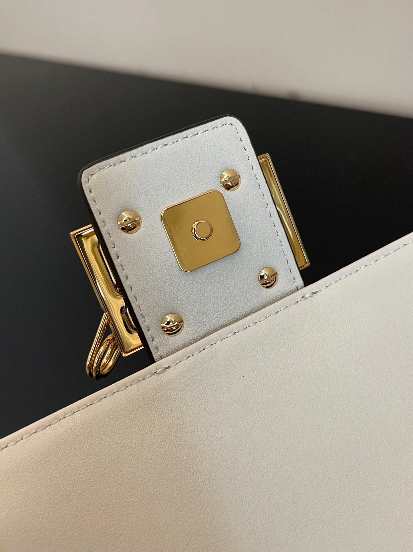 Elegant White Leather Mini Bag with Gold Flower Safety Pin Details