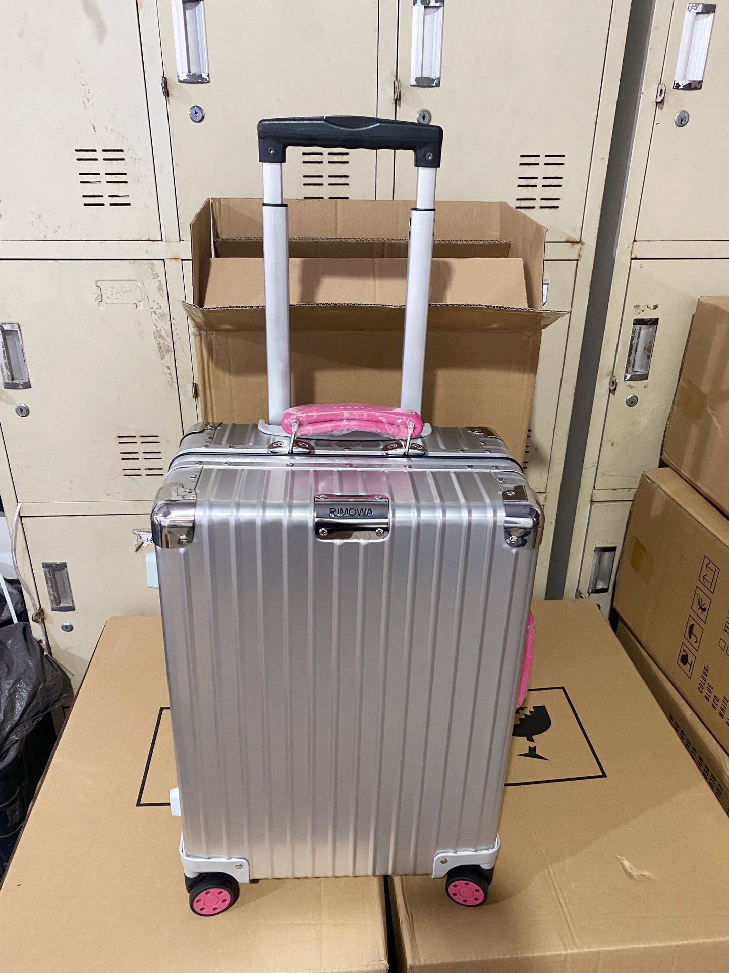 Silver Hardside Spinner Luggage with Pink Wheels and Handle