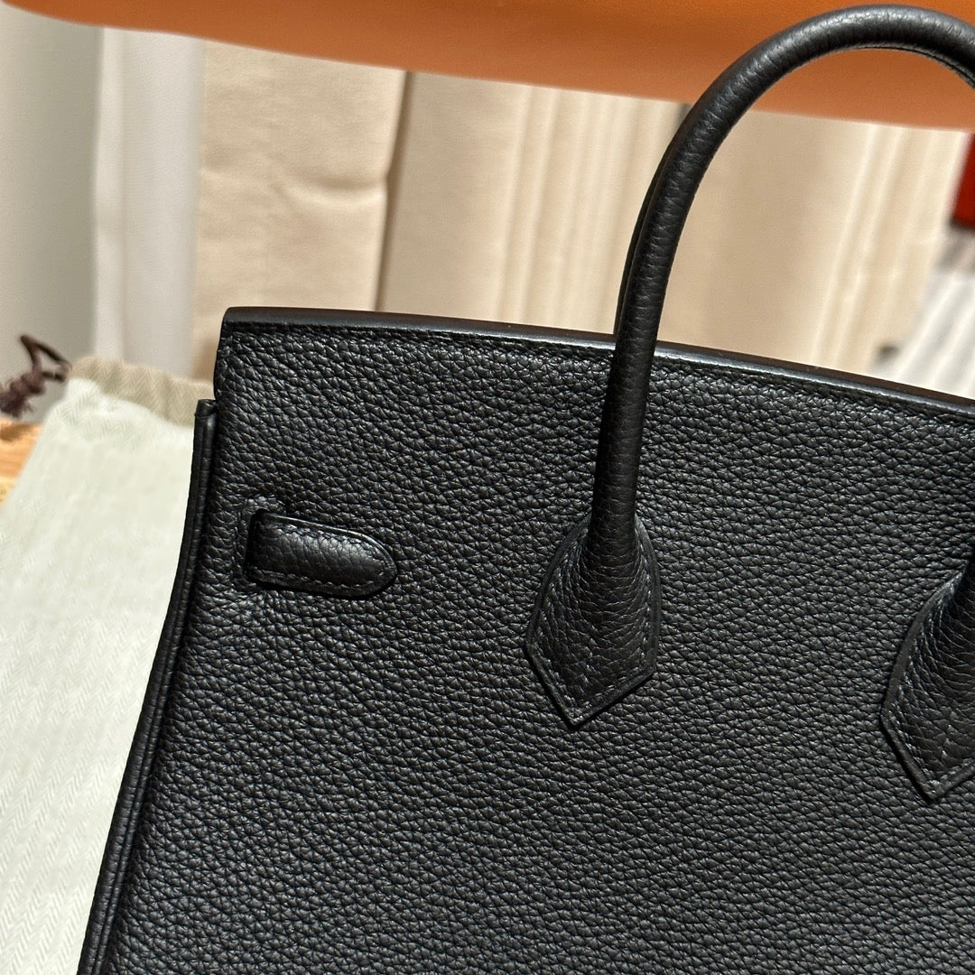 Luxury Black Leather Top-Handle Handbag with Horse Charm and Gold Hardware