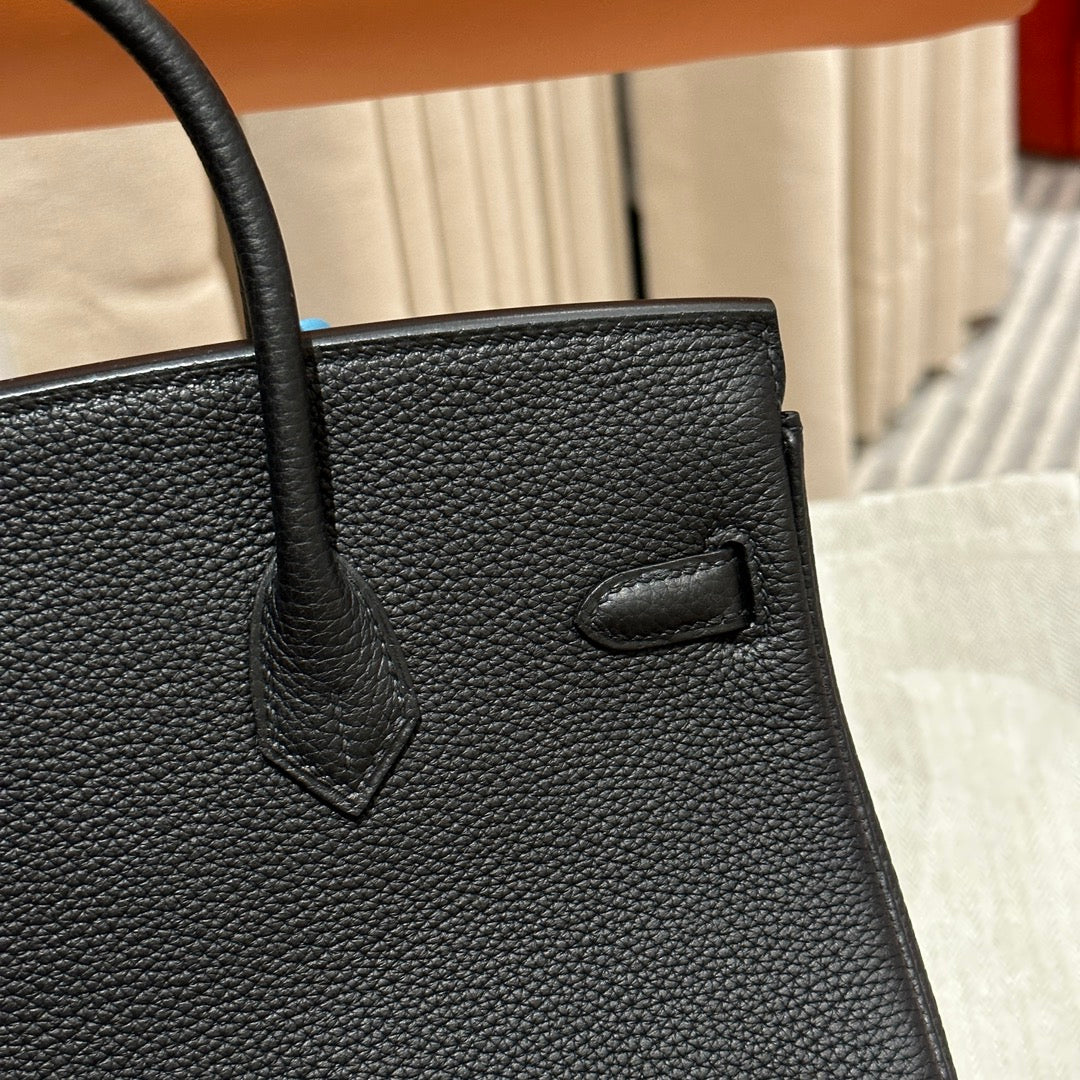 Luxury Black Leather Top-Handle Handbag with Horse Charm and Gold Hardware