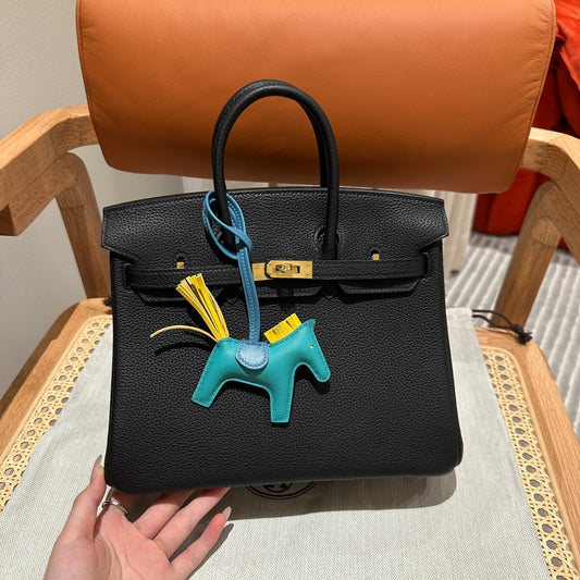 Luxury Black Leather Top-Handle Handbag with Horse Charm and Gold Hardware