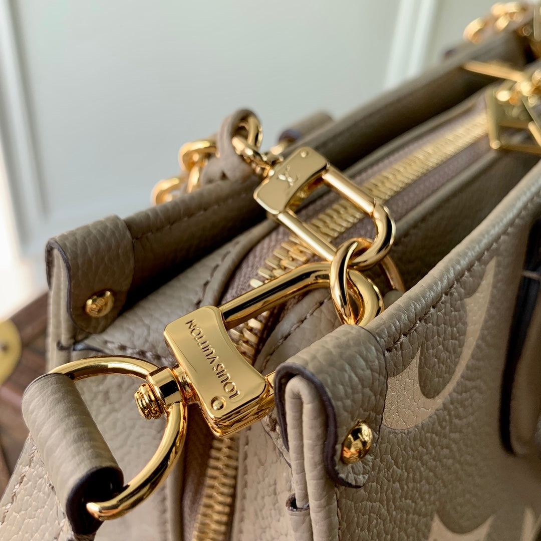 Louis Vuitton OnTheGo East West Bicolor Monogram Empreinte Leather Handbag - Tourterelle / Crème