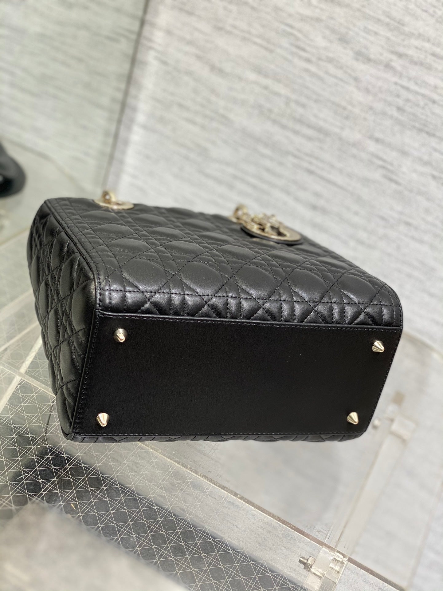 Dior Elegant Black Quilted Leather Handbag with Top Handle and Gold Charms