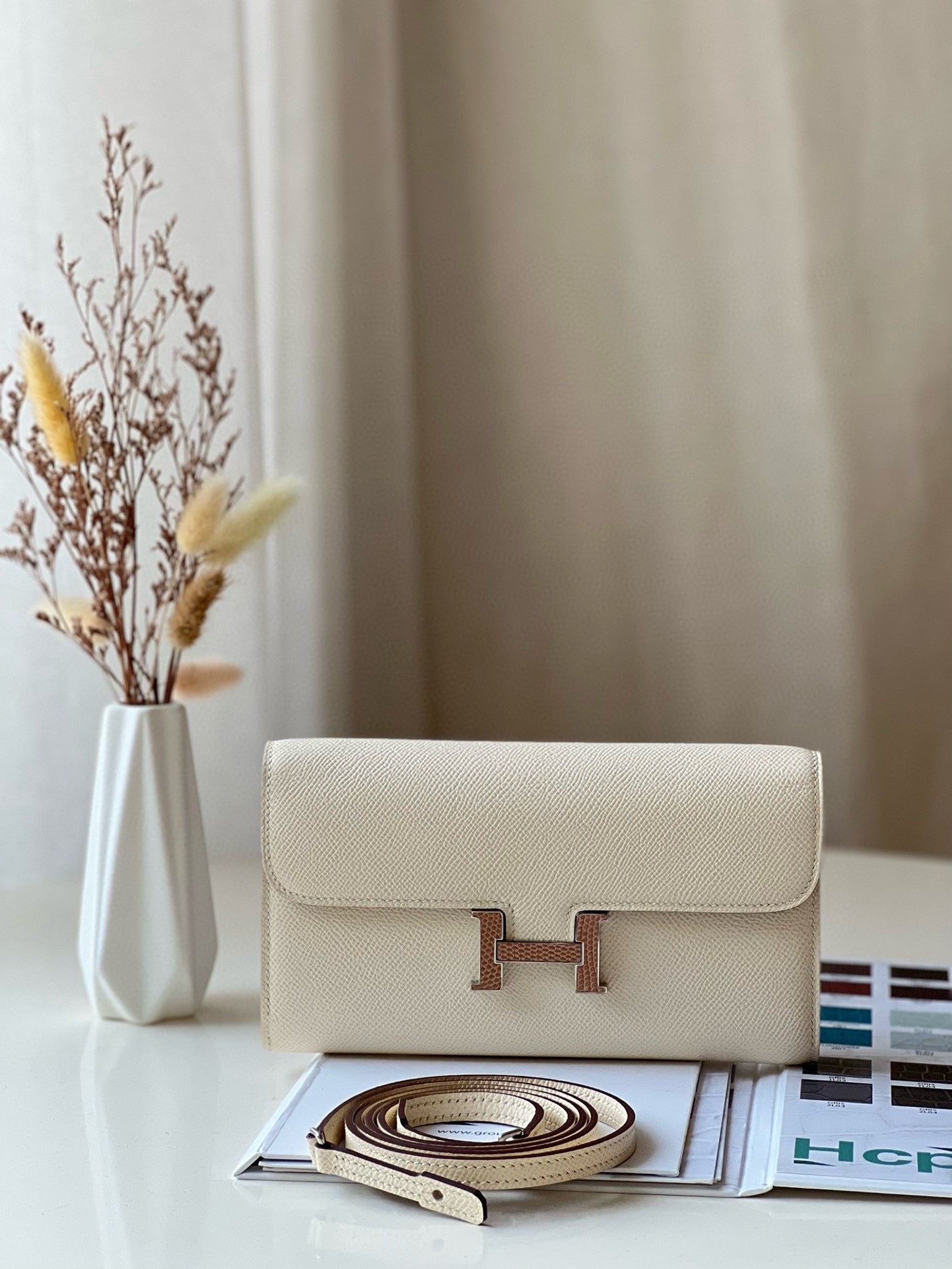 Elegant Cream Leather Crossbody Bag with Gold H-Logo Clasp