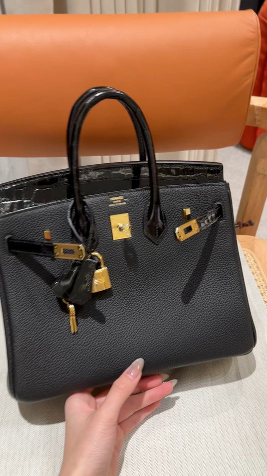 Luxury Black Textured Leather Handbag with Gold-Toned Hardware and Padlock