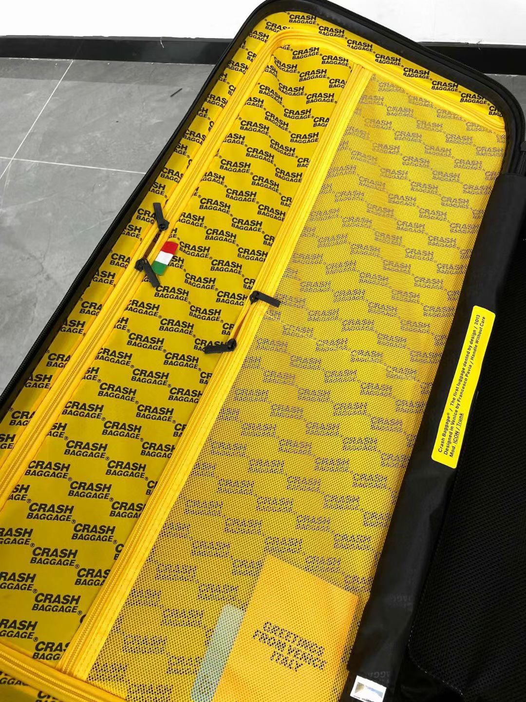 Black Spinner Carry-On Luggage with Yellow Accent Strap
