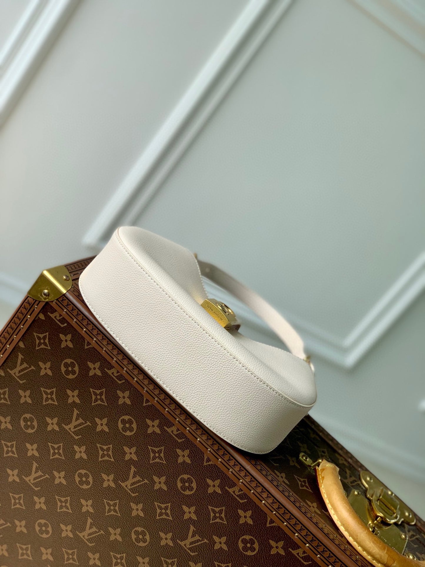 Elegant Cream Leather Crescent Shoulder Bag with Gold Padlock Detail