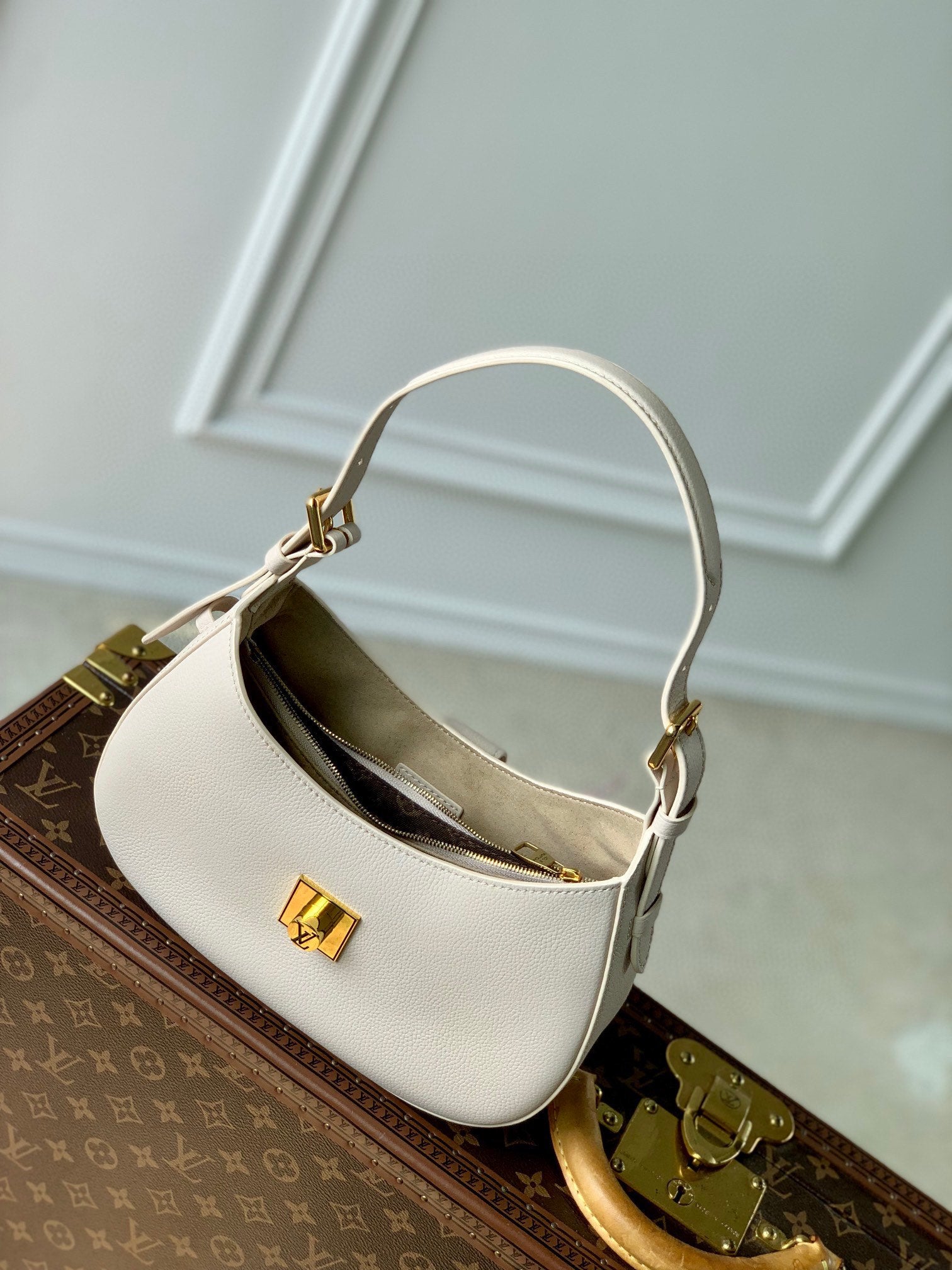 Elegant Cream Leather Crescent Shoulder Bag with Gold Padlock Detail