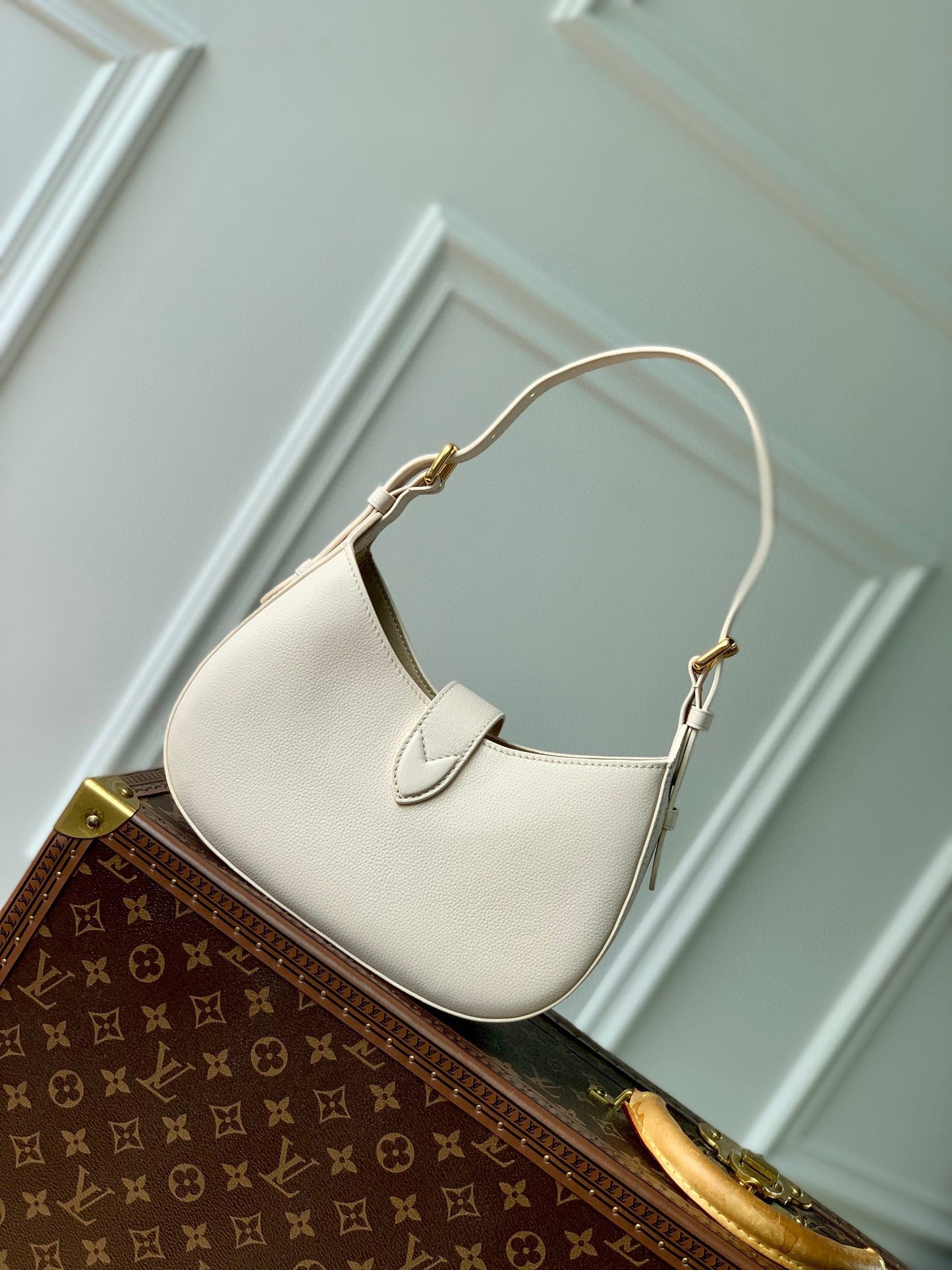 Elegant Cream Leather Crescent Shoulder Bag with Gold Padlock Detail