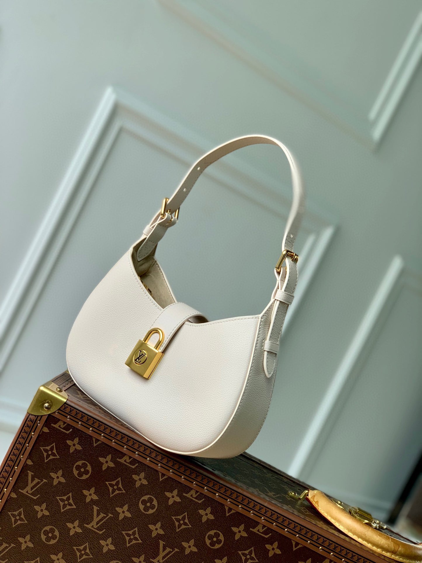 Elegant Cream Leather Crescent Shoulder Bag with Gold Padlock Detail