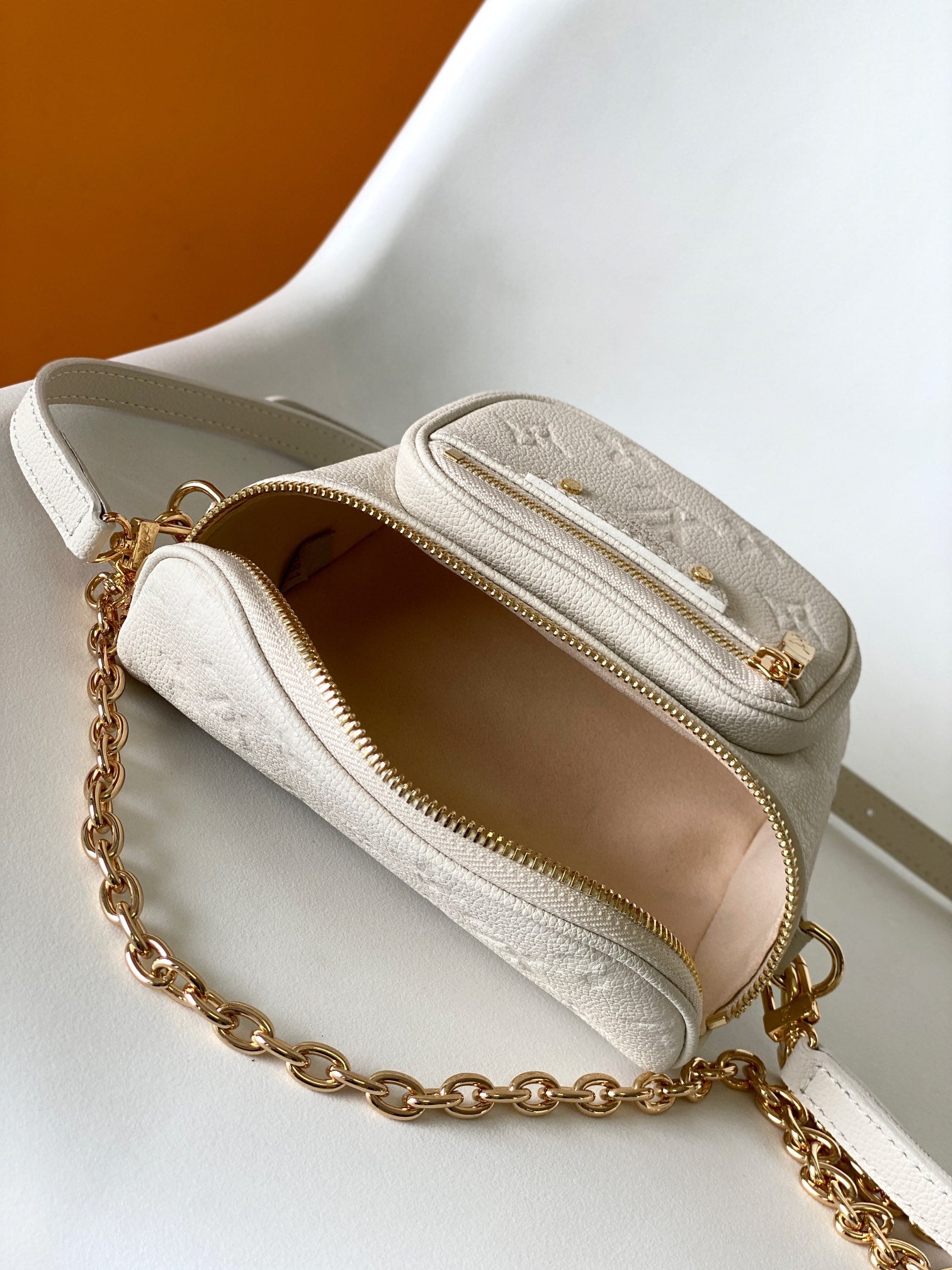 Louis Vuitton Elegant Cream Embossed Leather Crossbody Bag with Gold Chain