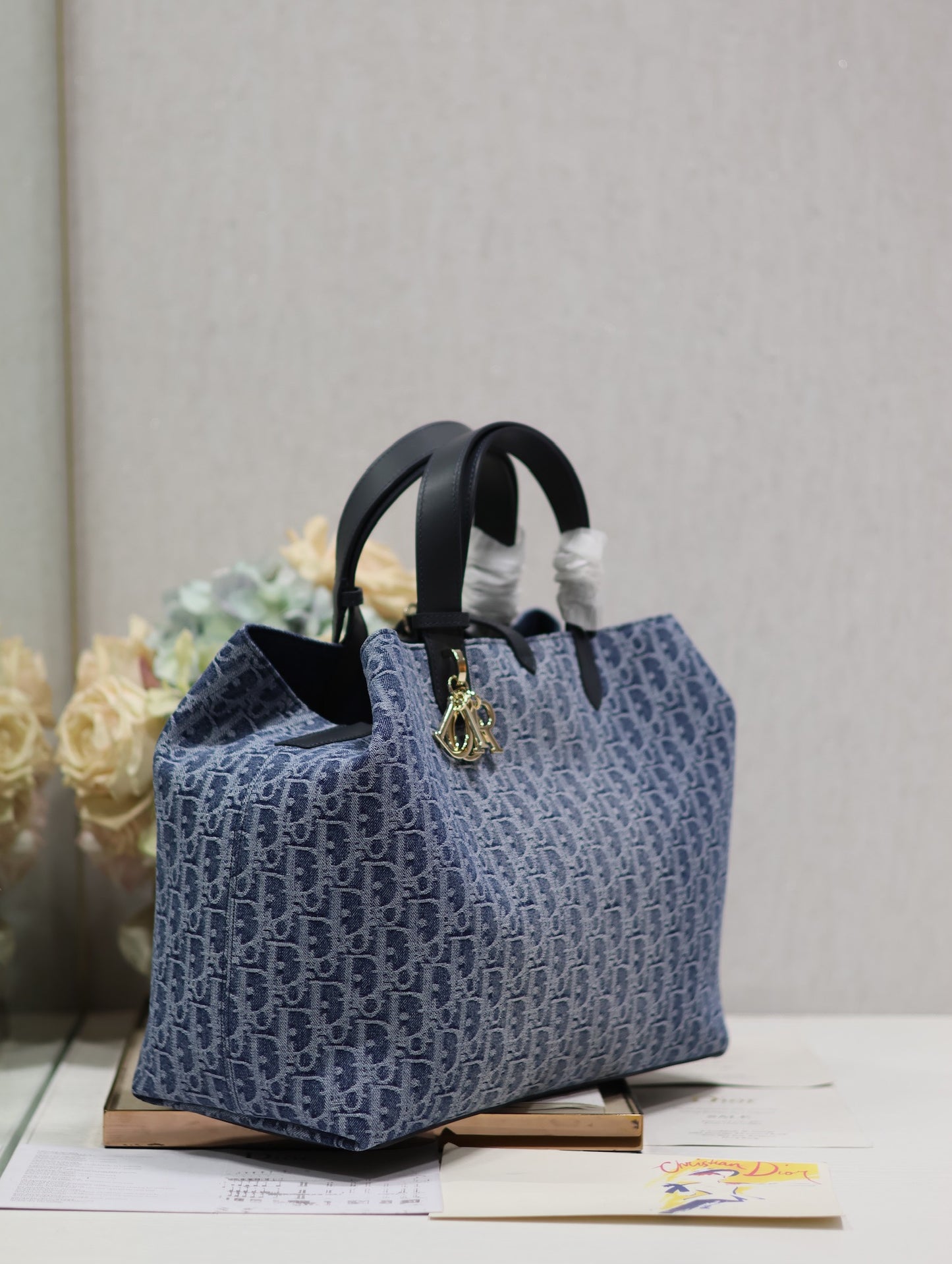 Vintage-Style Blue Monogram Canvas Tote Bag with Black Leather Handles and Gold Charm
