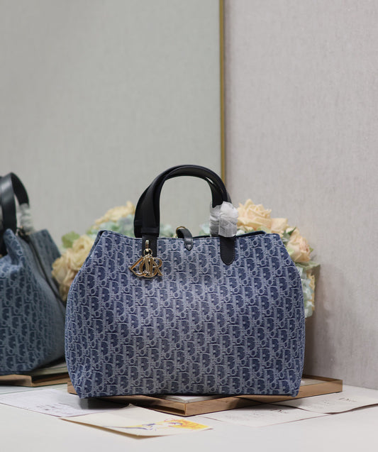 Vintage-Style Blue Monogram Canvas Tote Bag with Black Leather Handles and Gold Charm