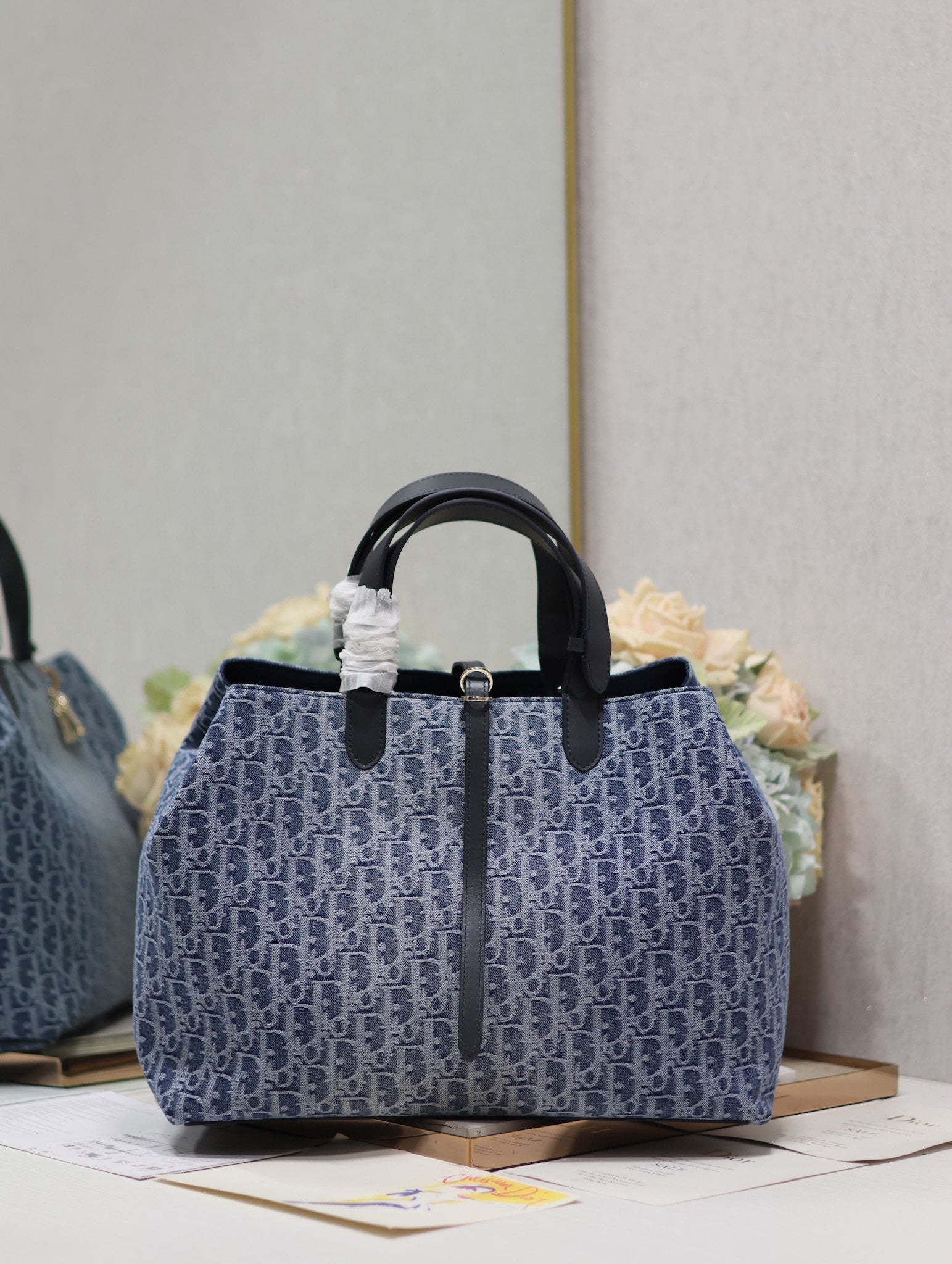 Vintage-Style Blue Monogram Canvas Tote Bag with Black Leather Handles and Gold Charm