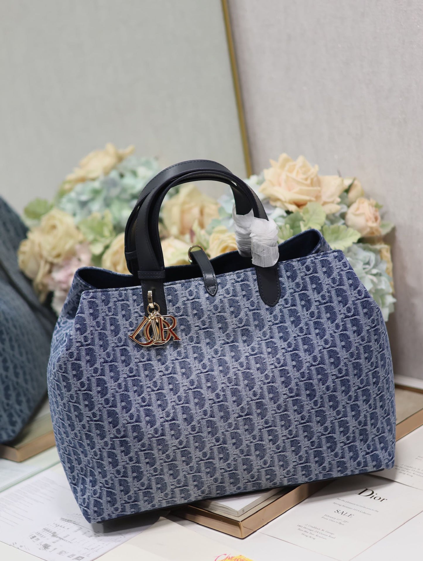 Vintage-Style Blue Monogram Canvas Tote Bag with Black Leather Handles and Gold Charm