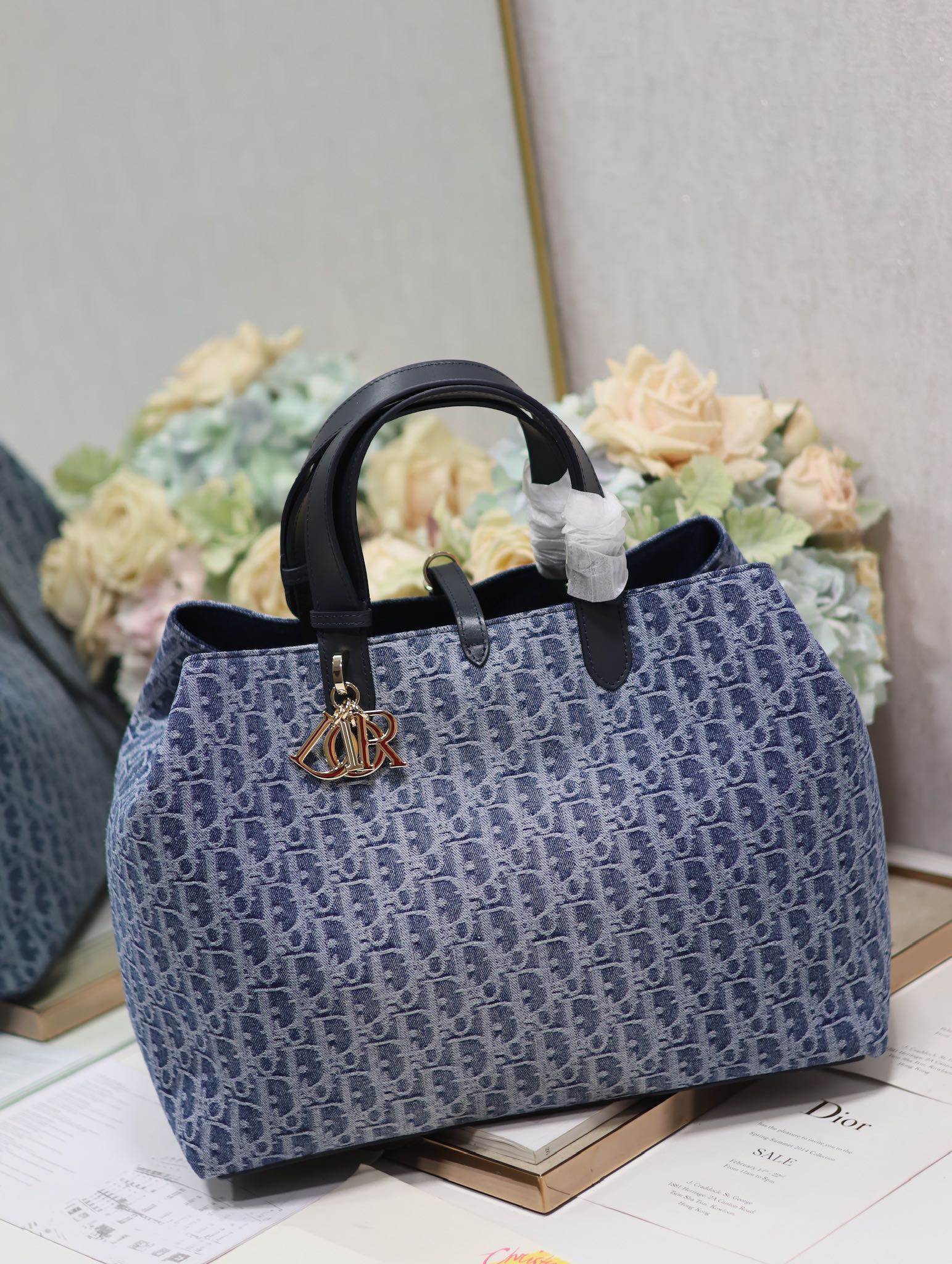 Vintage-Style Blue Monogram Canvas Tote Bag with Black Leather Handles and Gold Charm